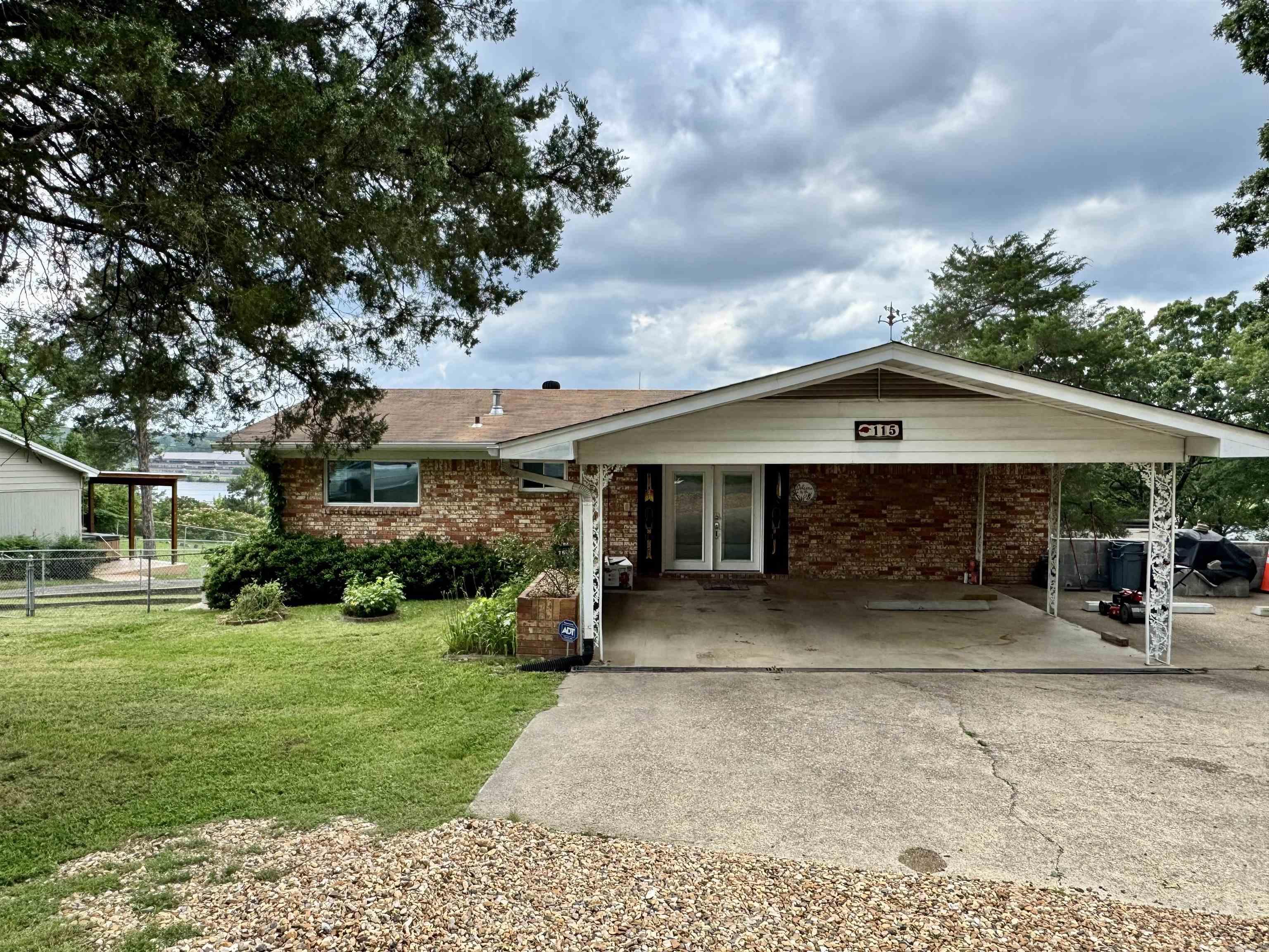The lake is calling!  Spacious and updated, this Lake Hamilton home is move in ready.  The open lake views will not disappoint.  This home was updated in 2023 and has a history of both short and long term rentals.  Featuring two levels with living rooms on both levels, 2 bedrooms, 1 full bathroom and kitchen upstairs and 2 bedrooms, 2 full bathrooms and a wet bar downstairs.  This home is designed to accommodate guests.  The outdoor space is abundant with a large covered deck upstairs and a screened in covered patio below.  The single stall boat dock sits along the 95 feet of shoreline. Selling fully furnished. Covered 2 car carport.  Bring all offers!