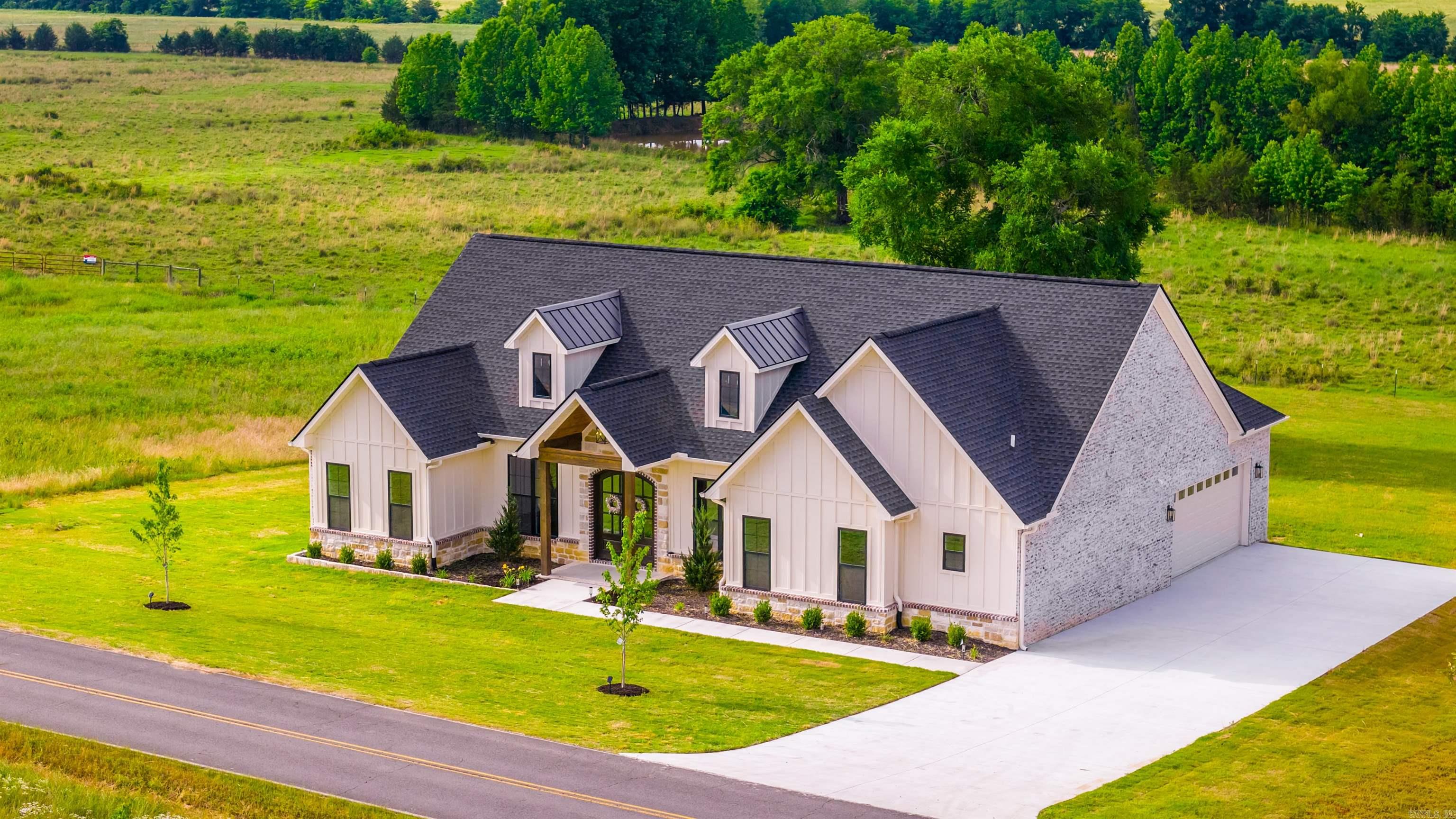 NEW CONSTRUCTION WITH POND VIEWS + UP TO $8,000 IN BUYER CONCESSIONS!  Welcome to 240 Castleberry Rd in Greenbrier, AR — a beautifully crafted custom home situated on approximately 0.75 acres with peaceful pond views and private country living. This 2,403 SF home features 3 bedrooms, 2.5 bathrooms, plus an office that could easily serve as a 4th bedroom or flex space. Inside you’ll find marble countertops, custom cabinets, custom tile work, tile flooring in wet areas, luxury vinyl plank flooring throughout, and stunning white oak built-ins in the living room. The spacious kitchen opens to the main living area and is perfect for entertaining. The primary suite offers a huge walk-in closet and a beautifully designed bathroom. Additional features include a tankless water heater, built-in interior storm shelter, side-entry garage, and a huge covered back porch overlooking the pond. Conveniently located near Greenbrier schools, shopping, restaurants, Hwy 65, Conway amenities, and Woolly Hollow State Park. Seller offering up to $8,000 toward closing costs, rate buy down, or a combination of both. Photos have been virtually staged. ***See Agent Remarks***