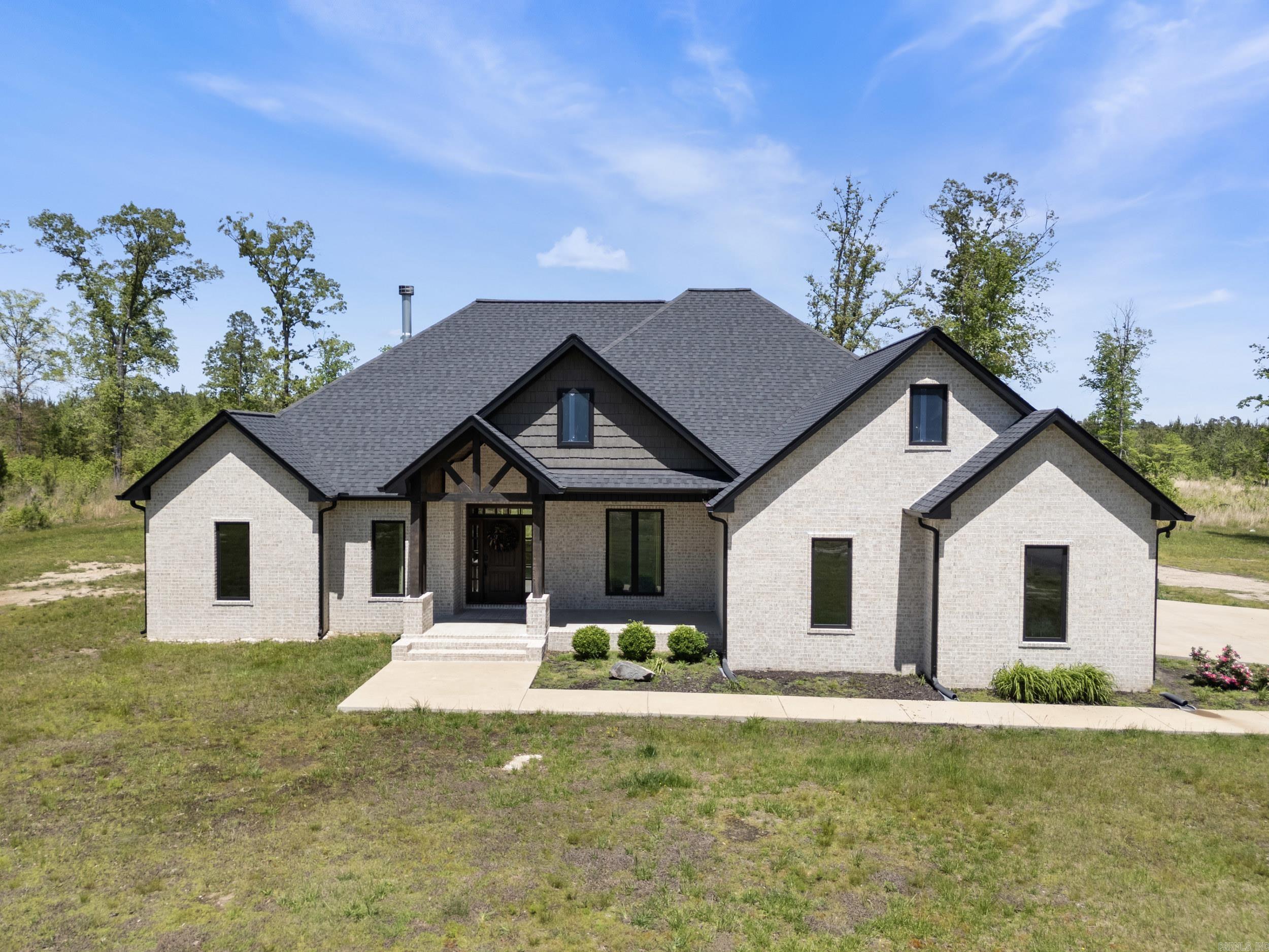 This beautiful custom home sits on just over 17 acres of land. This home is approx 2800 sq ft, and features 4 bedrooms, 2.5 bathrooms, and an office. Inside it has a wonderful open floor plan, with a beautiful wood burning fireplace in the living room. The kitchen has a gas cooktop, double ovens, granite countertops, an oversized island, and a large pantry. The primary suite has a walk in closet that you can access off the bath or by walking through the laundry area. The closet also has a center island wardrobe. Downstairs there’s 3 bedrooms, and a dedicated office space. Upstairs there is a bonus room. Outside you will find a spacious back porch with another wood burning fireplace. In the back yard there is a fenced in area, with a building that was used as a dog kennel. This home is wired for a generator, has spray foam insulation, a gas tankless hot water heater, and gas heat.