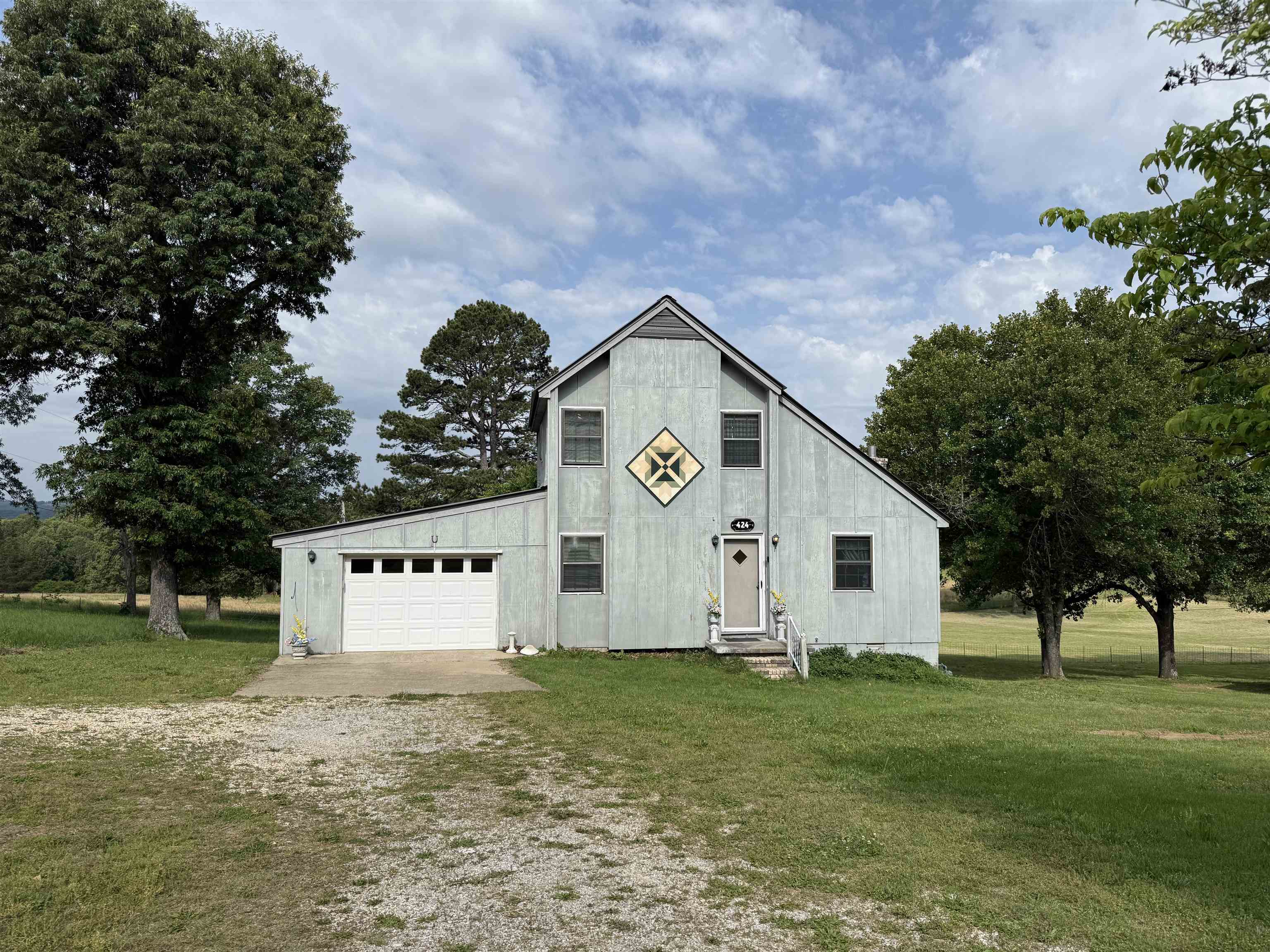 Charming and full of character this unique 3 bed, 2 bath home sits quietly on the edge of town. Enjoy peaceful views of the neighboring pasture and large pond from the screened-in back porch, complete with side decks on each side for extra outdoor entertaining and enjoyment. The home features a Jack-and-Jill bathroom upstairs and a walk out basement opens to a private patio area to enhance the home's uniqueness. Recent updates include a new HVAC system installed May 2026 along with other upgrades. The metal roof is only a couple years old as well, adding comfort and peace of mind for the new owners. This home checks the boxes for charm, privacy, and beautiful views all while being close to town.