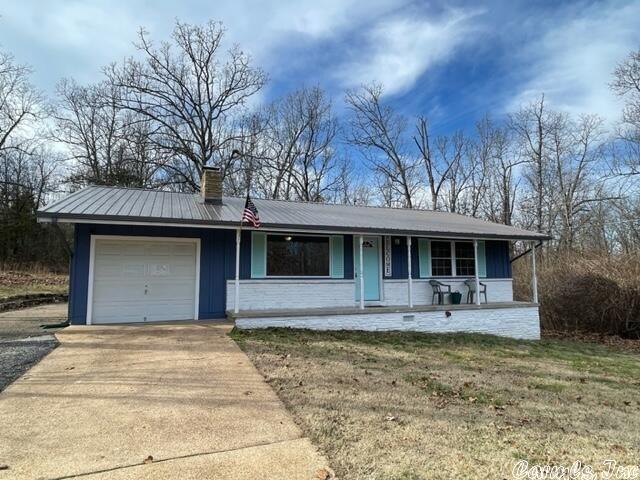 Nicely updated and secluded, this 3 bedroom 1 bath home sits on 2 lots. Home features an eat in kitchen with new appliances and a sliding door to the outdoor patio for grilling. Bedrooms are large sized and have good closet space, dedicated laundry space along with a 1 car garage. Home features metal roof, gutters, new double pane windows, lighting, and new vinyl plank flooring, HVAC has been serviced yearly, and septic cleaned out in 2019.