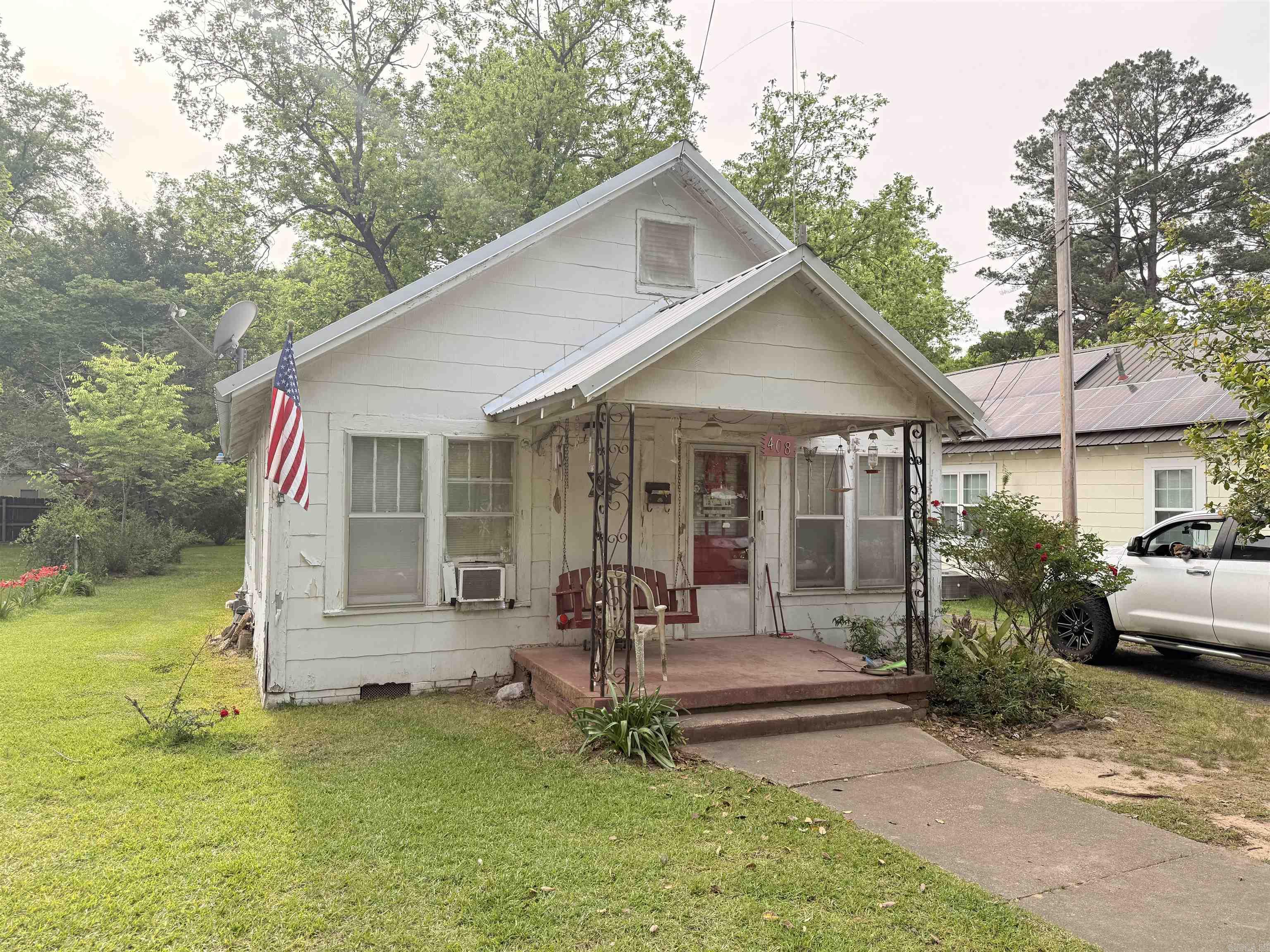 3-bedroom fixer-upper with timeless appeal — sold as-is and ready for restoration! This classic single-family home sits on a spacious lot with mature trees and a peaceful, established neighborhood setting. Featuring a welcoming front porch, metal roof, and original character, it offers excellent potential to be restored to its former glory. While the interior requires significant work     (including cleanup and updates), this is a solid    opportunity for investors, handy buyers, or  visionaries looking for a project with real heart.  Bring your tools and creativity — this one has the  bones to shine again! Sale is AS IS, WHERE IS and subject to court approval.