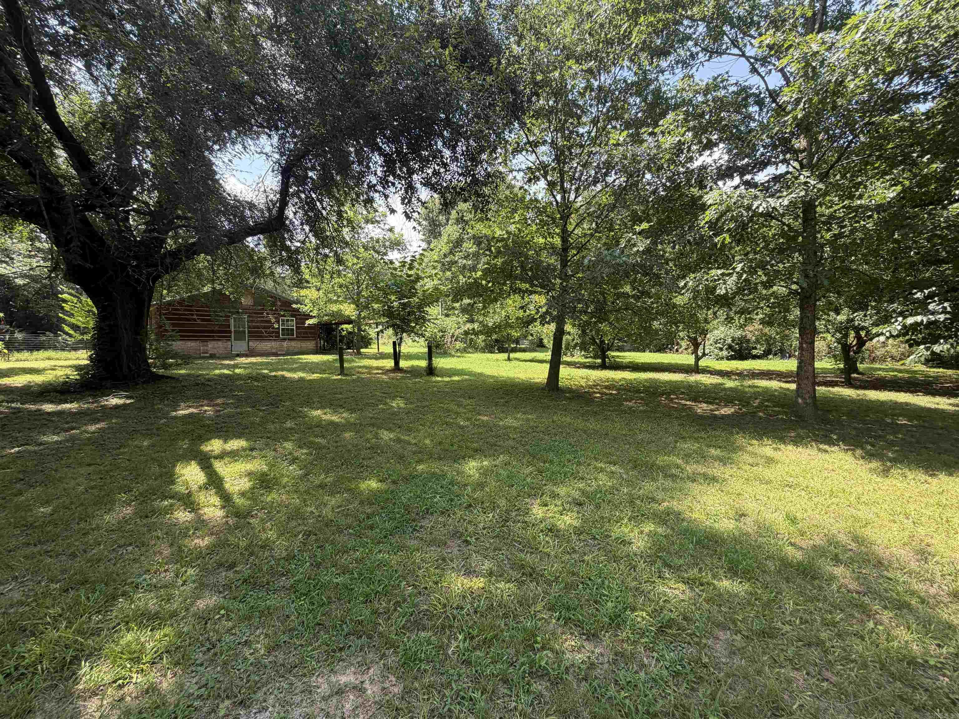 This 13-acre property on a paved county road has a nice pond and a fully fenced pasture for livestock. The house has 3 bedrooms, 2 baths, and needs some TLC. The wood stove does not convey. The property also has a stable with 3 stalls in a gated area. There is a spacious 30x50 metal Shop/Utility building with 110amp electric, a well house, fenced yard for pets, garden area for herbs and vegetables, and also peach and pear trees. The house is plumbed for propane. There is an additional site with electric, water, and septic ready for a mobile home or a new build.