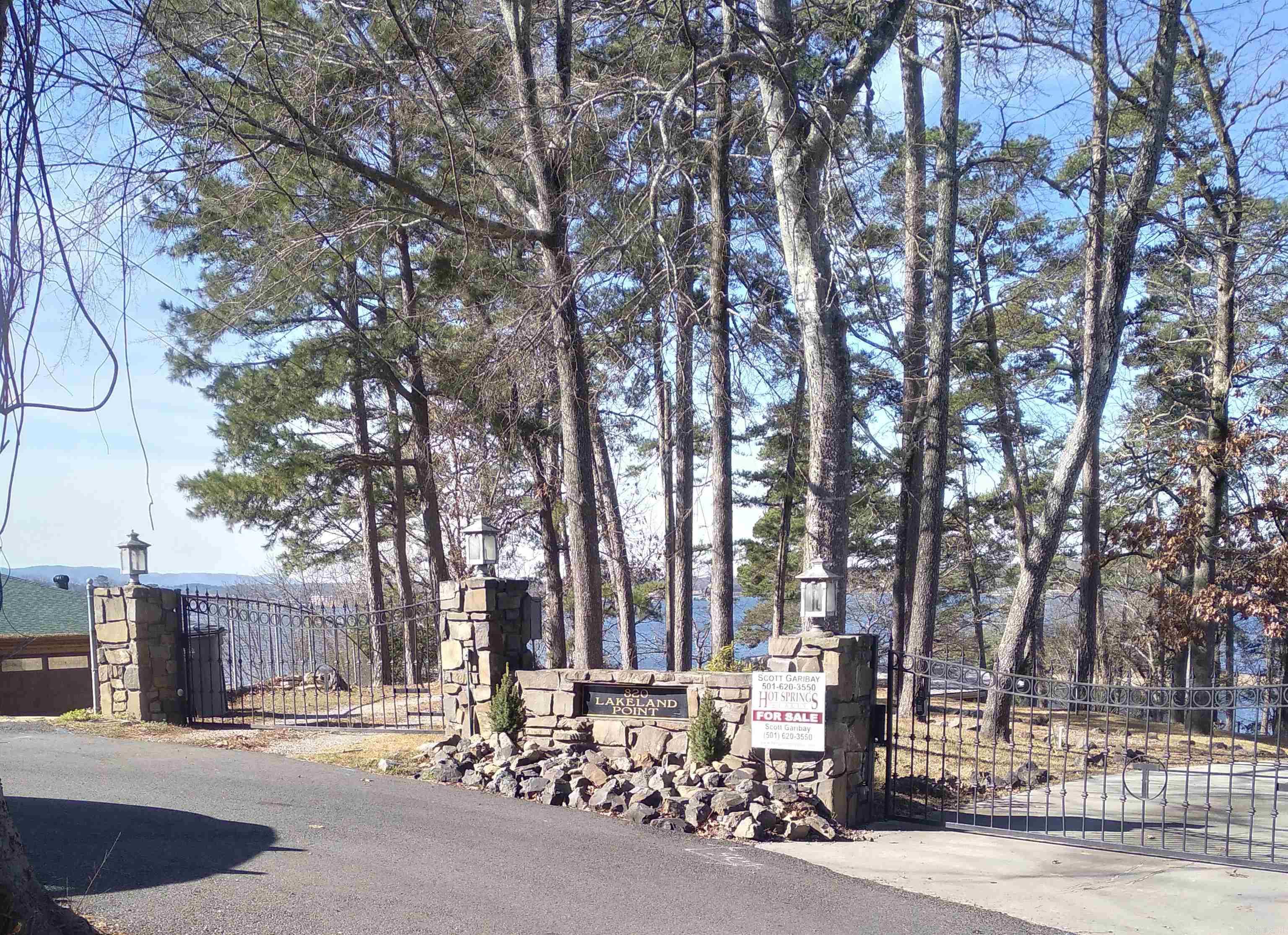 Step through the gated entry to a private, lakeside estate on the point at Lakeland Point, where panoramic Lake Hamilton views and serene privacy create a true retreat. Expansive glass walls in the main home capture the lake from nearly every room, blending rustic charm with modern comfort. The water's edge guest house/cabana and spacious lakeside patio offers the perfect setting for relaxing, entertaining and savoring the beauty and tranquility of life on the water!
