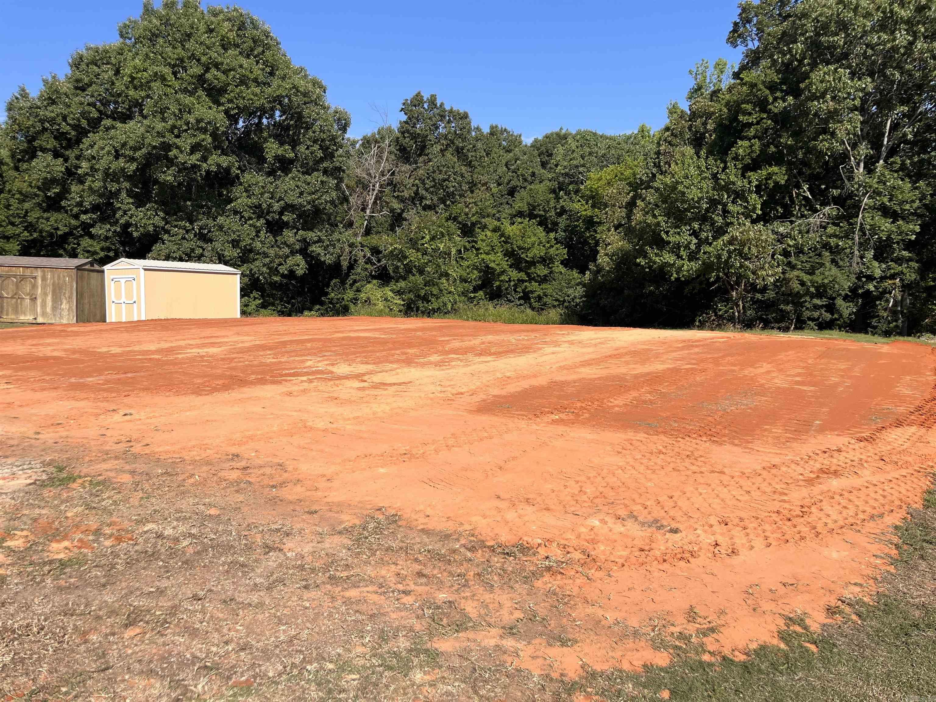 PAD READY site 80'x60'.   Zoned HC - Highway Corridor Commercial District, this property offers approx. 265' of frontage on Highway 49/Linwood Drive with two existing curb cuts/full-movement access adjacent to a signalized intersection. High traffic area, 26,000+ vehicles per day, is on one the primary corridors and within Paragould city limits. Utilities available.  Paragould is a growing community with a solid population base, stable employment, and an expanding trade area that supports grocery, QSR, healthcare, neighborhood retail, and service-oriented concepts.This opportunity sits at the heart of Paragould's expansion, with the vast majority of the city's development & investment funds pouring into the immediate area.   Currently used to sell portable buildings - the property is NOT under a lease and there are NO permanent structures on the property. Existing business can be moved at any time.  Two adjoining parcels total approx. 1.19 acres.