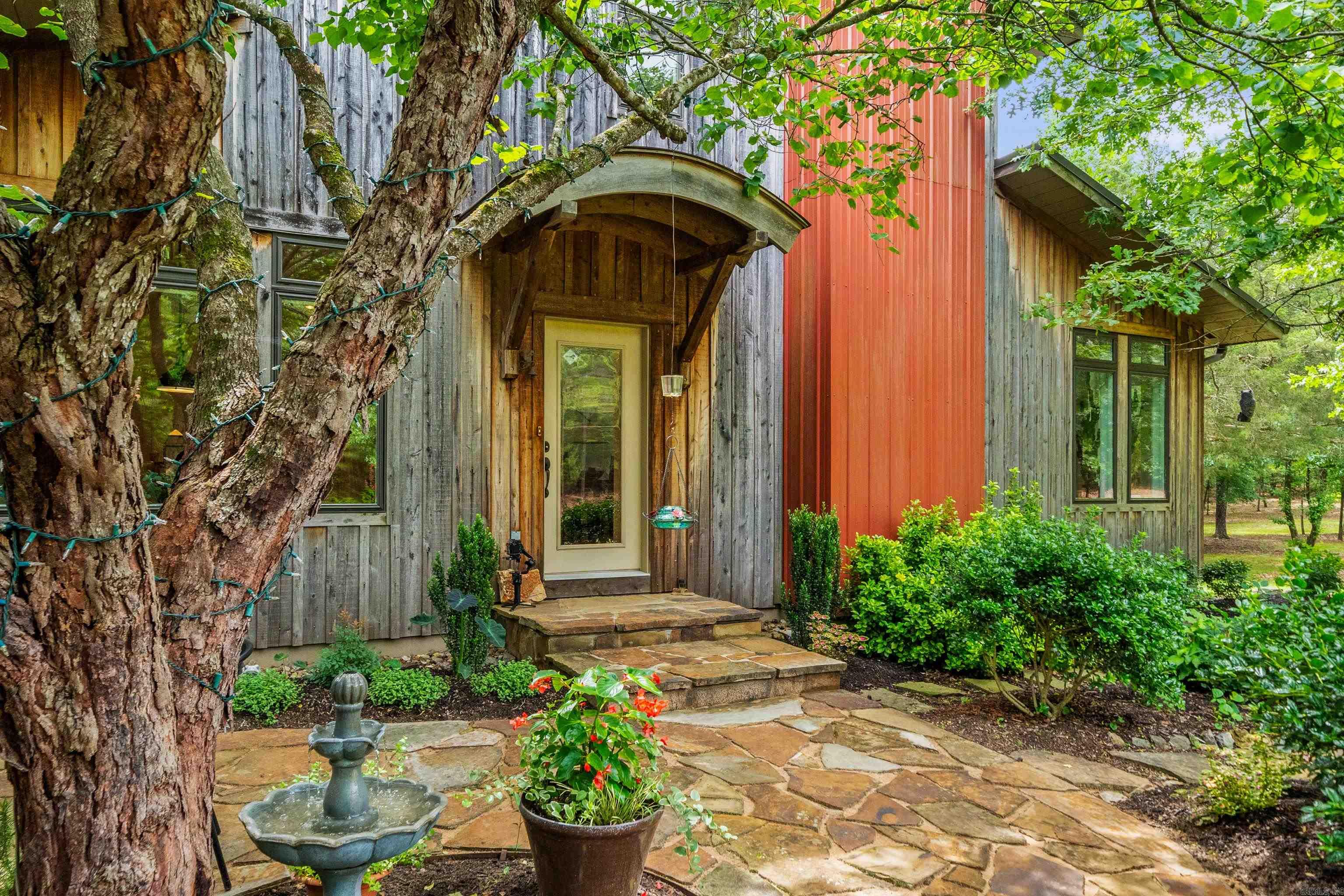 Discover peaceful country living in this energy-efficient, architect-designed, 3 bedroom 3 bath home set on 42 acres of natural beauty. Thoughtfully crafted for comfort and sustainability, this one-of-a-kind property blends modern efficiency with the tranquil charm of the outdoors. Step onto the expansive back porch and take in stunning views of the serene backyard, where wildlife is abundant—deer graze, birds sing, and baby owls can be seen growing in their own dedicated owl house. Several small creeks meander through the property, enhancing the peaceful ambiance. Wander the private trails through mature woods or relax in the beautifully landscaped yard. A large workshop with an attached garage provides ample space for projects, while a greenhouse allows for year-round gardening. There's even covered parking for an RV or boat. Home features cedar exterior, hickory hardwood floors, soapstone countertops in kitchen, filter system for well and backup propane generator. (these are just a few) Whether you're seeking a quiet retreat, a place to explore nature, or a property with room to grow, this unique homestead offers it all! (more info in associated docs)