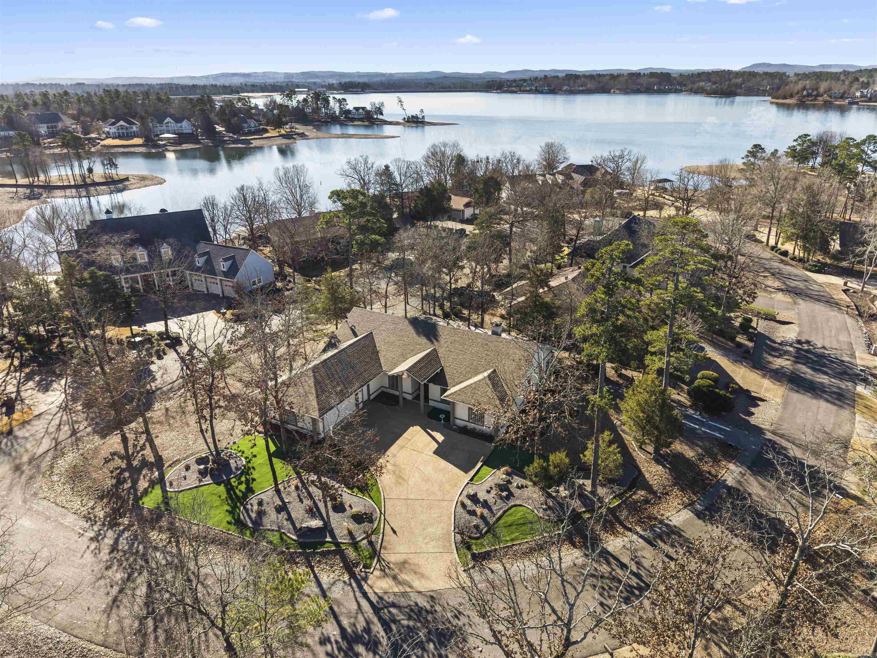 7 Resplandor Loop | Lake Balboa Views & Solid Build Experience peace of mind and luxury in this rare build: concrete walls with stucco exterior situated on a level, walkable street with beautiful views of Lake Balboa. This property combines "built-to-last" durability with a thoughtfully designed interior.  Home Highlights:  Perfect Layout: A split floor plan ensures primary suite privacy. Features include a large open living room with vaulted ceilings, a formal dining room, and a separate breakfast area.  Flexible Living: 4 bedrooms, office/sunroom off of primary bedroom, laundry room, Arkansas room, and screened-in patio for year-round enjoyment.  Modern Upgrades: Recently replaced roof, leaf guard gutters, new hvac, kitchen with updated appliances and countertops, and  professional landscaping with rock and Astroturf for effortless, low-maintenance curb appeal.  Parking & Storage: Level lot with a large driveway for easy turn-arounds, a dedicated golf cart/trailer parking area, and oversized garage with space for workshop and storage.  This property is located on a flat, easily walkable area surrounded by Lake Balboa, and only a short drive to Balboa Marina and the Balboa Gate.