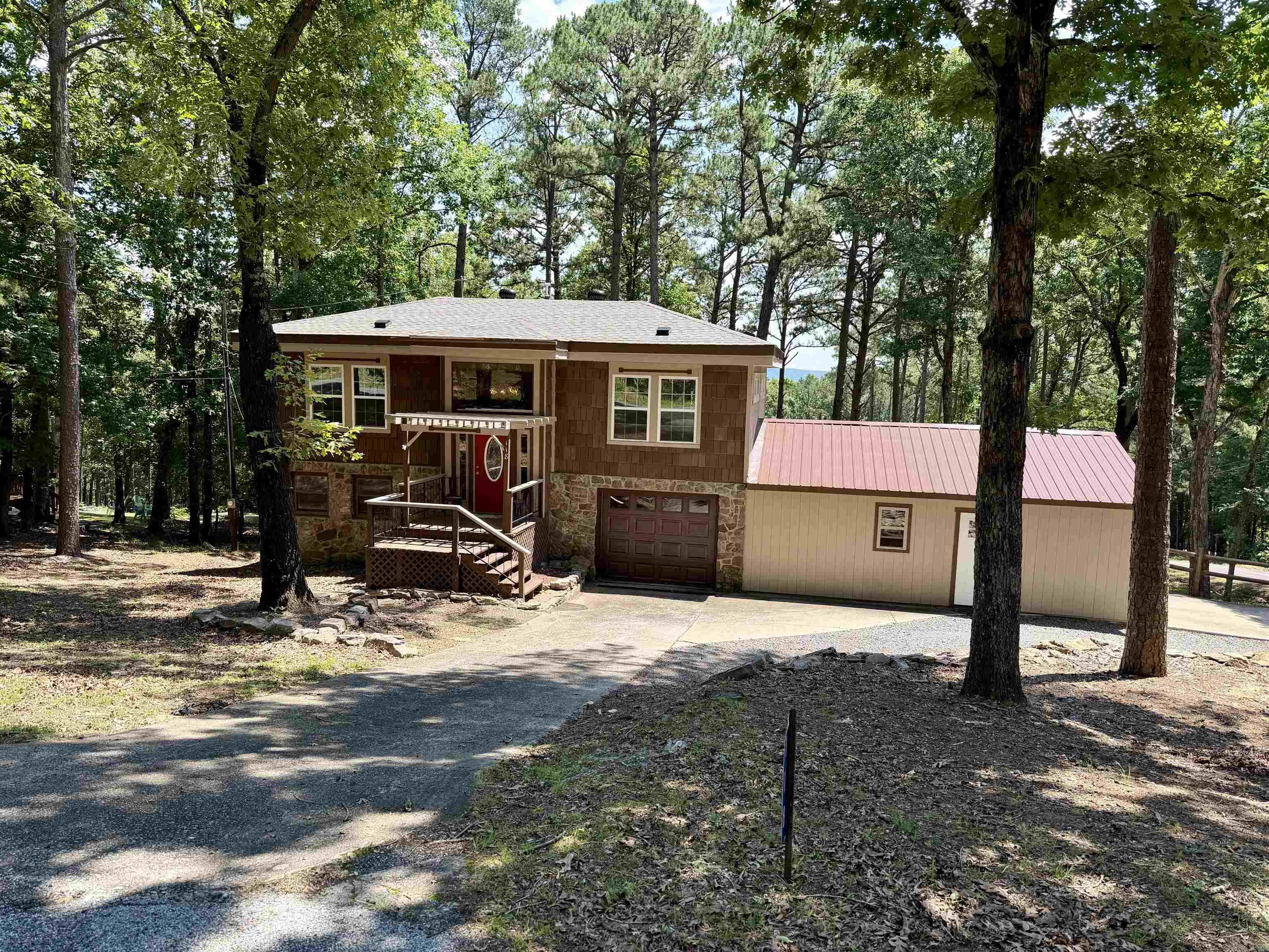 Looking for a move-in ready home near the lake with quality upgrades already completed? This beautifully remodeled Fairfield Bay home offers the perfect combination of comfort, convenience, and long-term value. Recent improvements include a new Lennox HVAC system, premium DaVinci roofing shingles, new windows, front door, patio doors, updated fixtures throughout, and a new grinder pump. Inside, you'll love the warmth and character of the solid pine wood floors and the completely renovated bathroom featuring dual showerheads for a spa-like experience. The home also offers exceptional parking and storage with an attached two-car garage plus an additional single-car garage. The owned propane tank adds extra value, while fiber internet availability makes working remotely or streaming a breeze. Located just blocks from the Fairfield Bay Marina, this property offers seasonal lake views and easy access to all the outdoor recreation Fairfield Bay is known for. Need more room? Two additional lots are available for purchase, providing extra privacy, future building opportunities, or room to expand. Most furnishings can be purchased additionally!