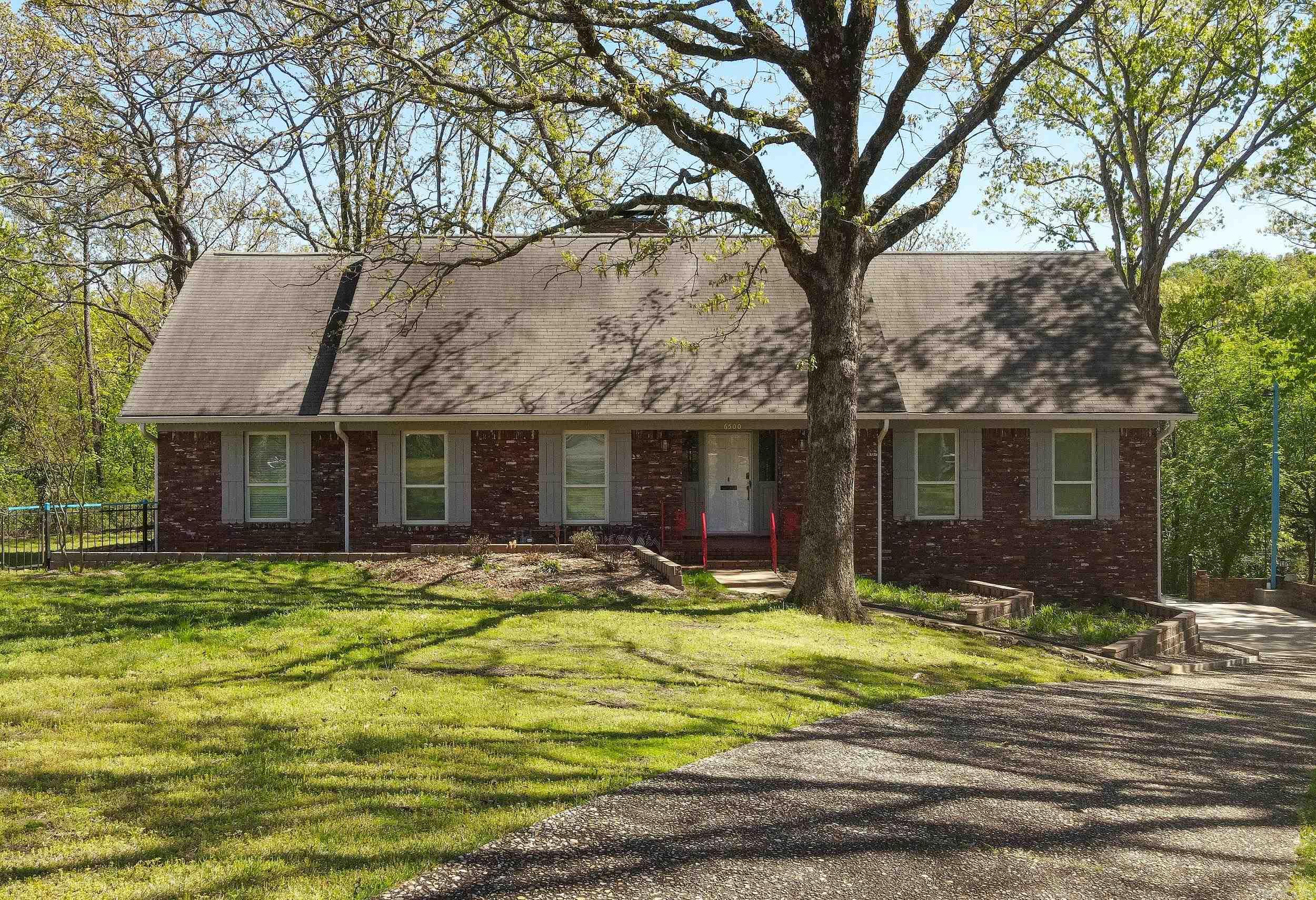 Tucked away on a quiet cul-de-sac, this beautifully updated lakefront home sits on 0.78 acres with a peaceful creek along the back and scenic views from nearly every window.  Inside, enjoy new carpet and flooring, fresh paint, new windows, and a fully renovated kitchen and bathrooms with modern finishes. Multiple living spaces include a heated and cooled sunroom, a cozy den with a wood-burning stove, and a versatile downstairs bonus room—perfect for a home office, media room, or guests.  Additional features include a tankless hot water heater, whole-house water filtration system, and exterior storage. This move-in-ready home combines modern updates with an unbeatable setting—perfect for those seeking comfort, beauty, and a connection to nature.