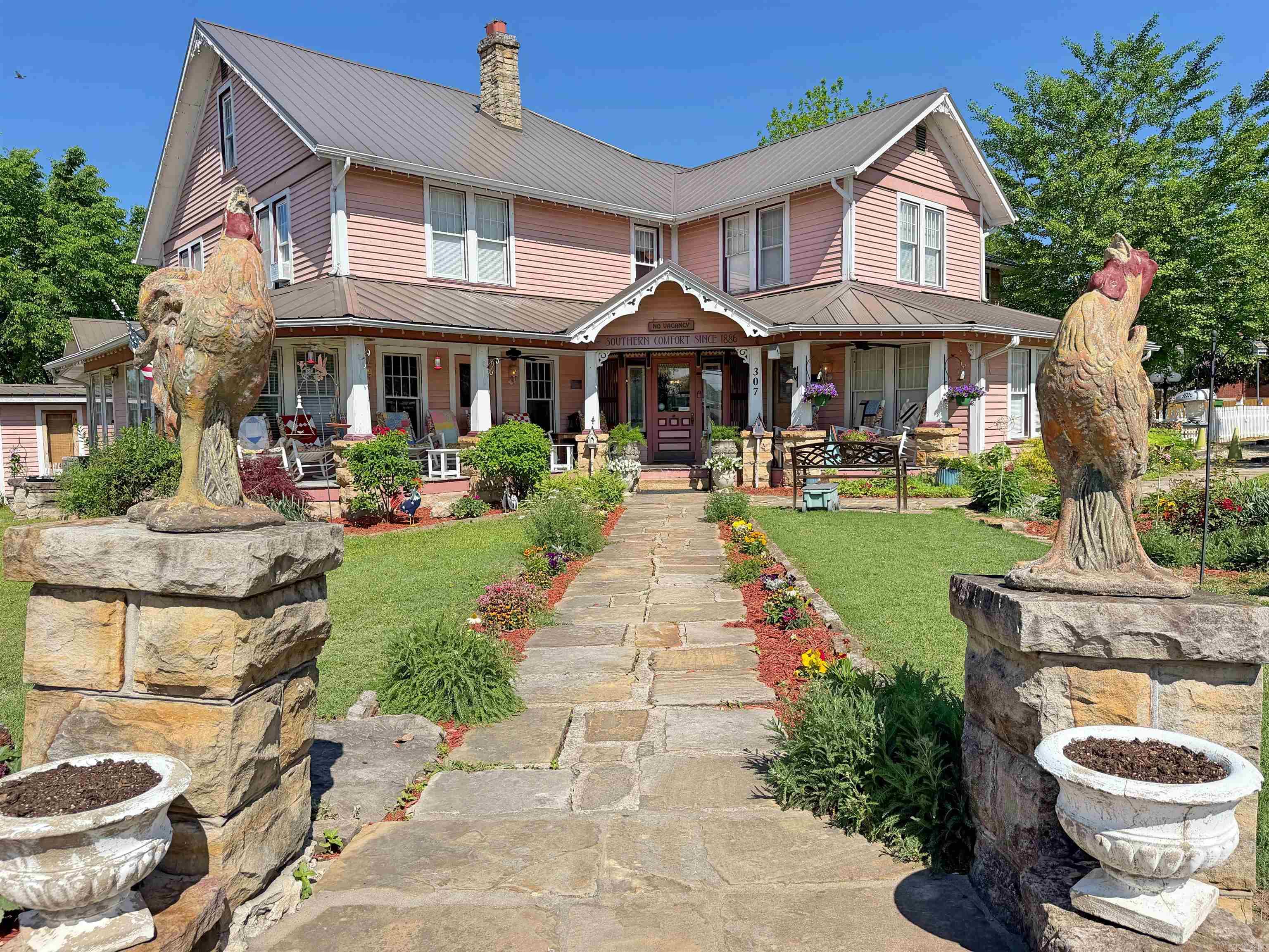 Located in the heart of downtown Mountain View and directly beside the Pickin’ Park, the historic Inn at Mountain View Bed & Breakfast offers a rare opportunity to acquire a well-established hospitality property in a high-traffic tourist destination.  Built in 1886 and listed on the National Register of Historic Places, the property features approximately 7,924 sq ft of inn space along with a 930 sq ft owner’s quarters that includes 3 bedrooms and 2 full baths, all situated on 1.09 acres.  The inn includes 10 guest rooms and suites, each with a private bath, along with multiple common areas, including parlors, covered porches, and a dedicated meeting/recreation space. The layout supports a wide range of guests, including tourists, family reunions, and musicians seeking a comfortable place to stay.  Offered fully furnished, this turnkey business allows for a seamless transition to new ownership. Its walkable location provides immediate access to local attractions, live music, shopping, and dining, making it a consistent draw for visitors year-round.