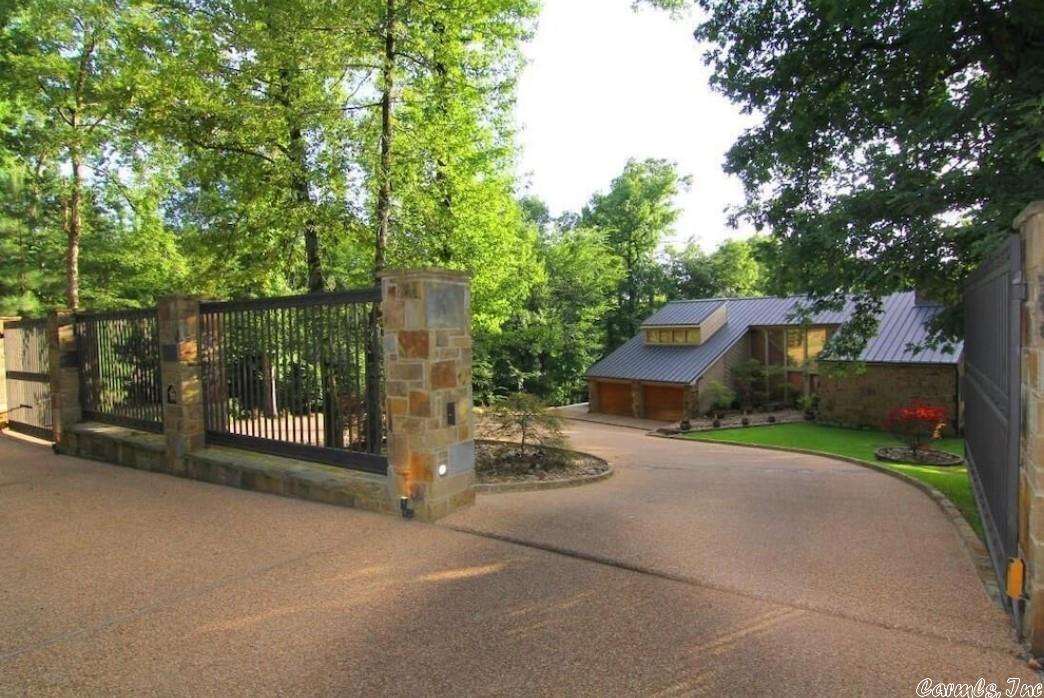 Upon reaching 100 Golden Oak Place, you'll be impressed by the Hackett Stone and Iron fence with gated entry into this lake estate. The Hackett Stone is found on both the exterior and interior of this beautiful property. This 'Lodge Look' home has plenty of attention to detail. From the vaulted ceilings to the Antler chandeliers this home has it all. Sitting on almost an acre and a half, the outside area is just as impressive. The oversized swimming pool has a gazebo and the fixed dock has two stalls.