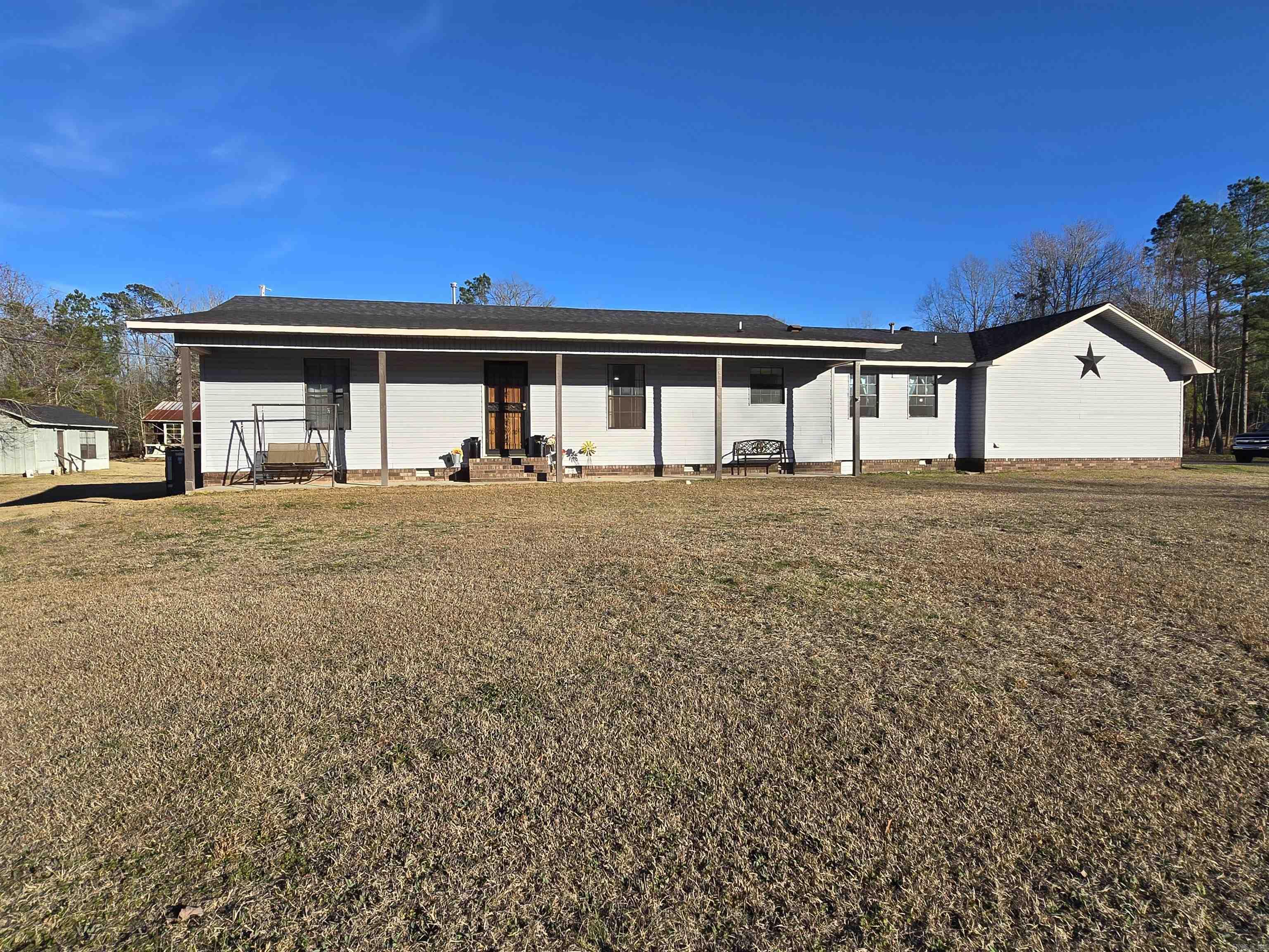 *Back on the market at no fault of the property or seller*  This spacious property offers the perfect blend of functionality, comfort, and country charm. The land is well-improved with two barns—the main barn measures 34x70 with 200-amp power, while the second barn is ideal for animals or equipment storage. You’ll also find two utility buildings, including a 16x21 building with a window unit air conditioning, plus an additional small tin building for extra storage.  Relax on the 10x46 covered back porch and enjoy the peaceful surroundings, complete with timberland and a year-round creek that truly enhance the country living experience. Major upgrades add tremendous value, including a new HVAC system in 2022, new roof completed in 2023, a storm cellar, and a whole-house generator for peace of mind.  The home features mostly 36-inch interior and exterior doors, a circle drive, and three exterior security lights for added convenience and safety. All of this is located just a short distance from Main Street Malvern, offering privacy without sacrificing accessibility.
