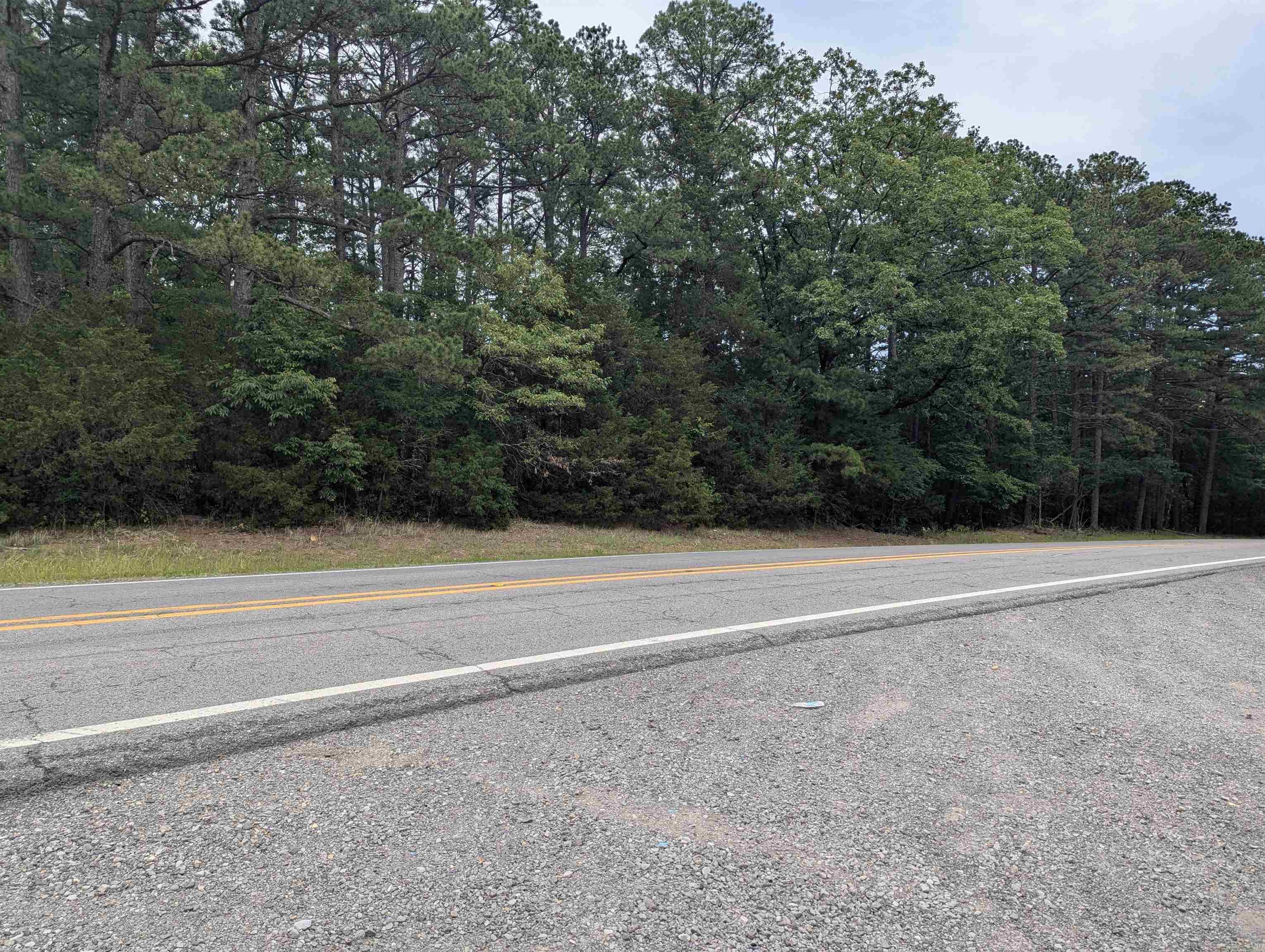 Looking for some Highway 16 road frontage, here are 10 acres of wooded unimproved property just waiting for you.  Beautiful hard woods and some pines cover the property with a couple of possible homes sites, or build a pond in the valley if that is your preference.  Fiber Optics are in place and there will be a sign on the property.