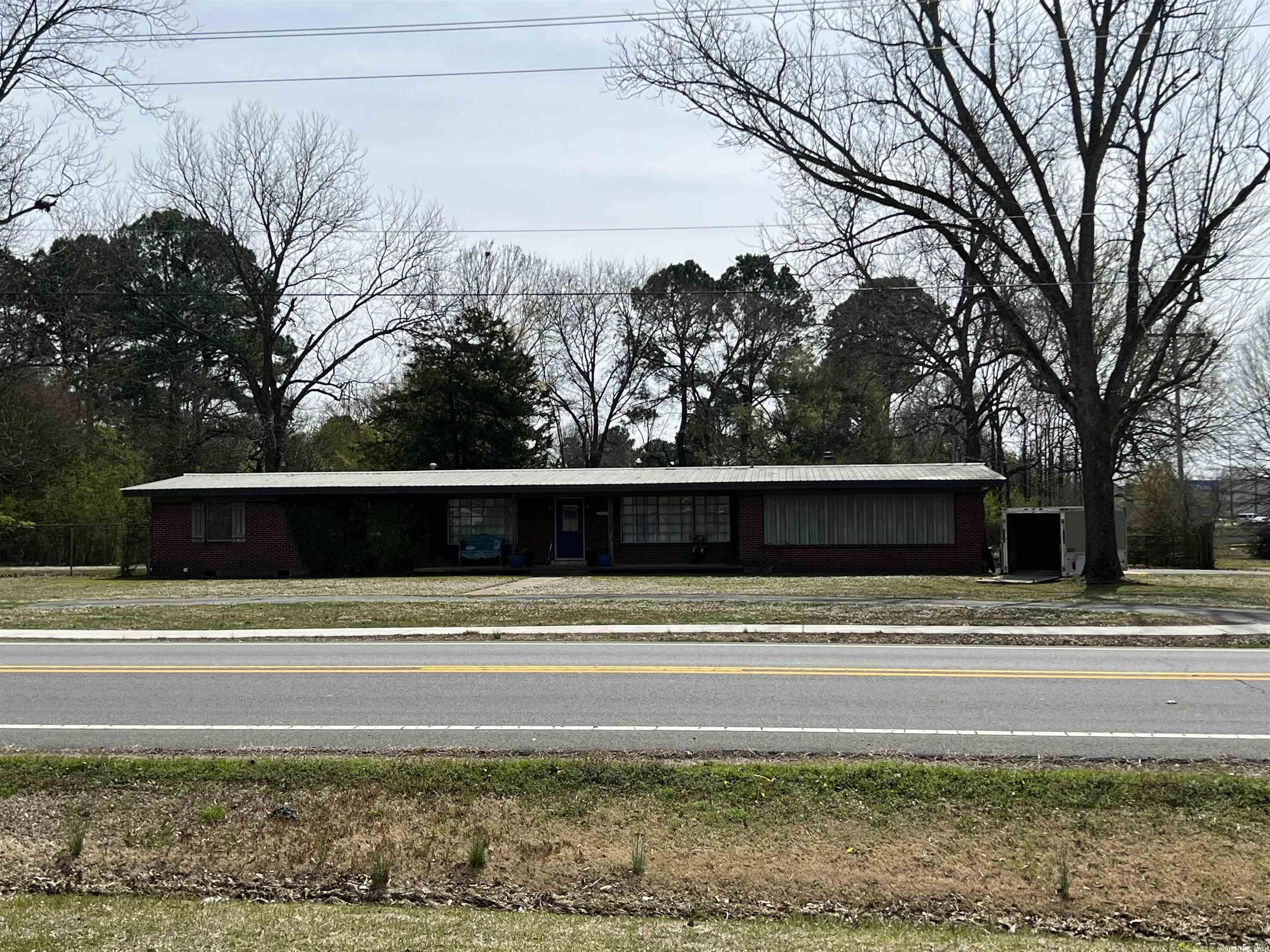 HIGH TRAFFIC COUNT! Close proximity of Wal-Mart Super Center & other fast growing businesses. Recently zones commercial. Presently 1708 sq.ft. home on  property. Less than 1/2 miles from interstate. Additional acreage available, SEE MLS#23008178