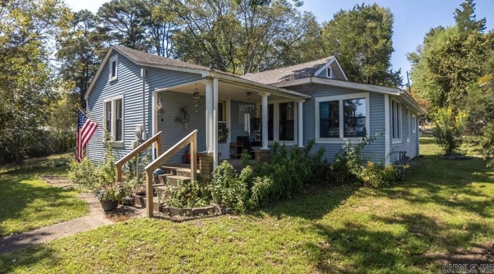 Charming Cottage with Peaceful Views + Bonus Lot! Welcome to this adorable 3-bedroom, 1.5-bath cottage perfectly positioned to take in beautiful rolling hill and pasture views right from your front porch. Step inside to find a warm and inviting layout featuring a spacious den, giving you plenty of room to relax, gather, or spread out comfortably. Out back, enjoy a large deck--ideal for entertaining guests or simply unwinding at the end of the day. And don't miss the screened-in porch, the perfect spot for enjoying summer evenings without the bugs. As an added bonus, this property includes an extra unrestricted lot, offering endless possibilities--build, expand, or keep it for added privacy. Cozy charm Scenic view  the additional lot adds 1.25 acres with separate septic & utilities to give the option of placing a mobile or other dwelling. Behind the house you'll find a detached double carport, with a space for RV behind that with it's own light pole.