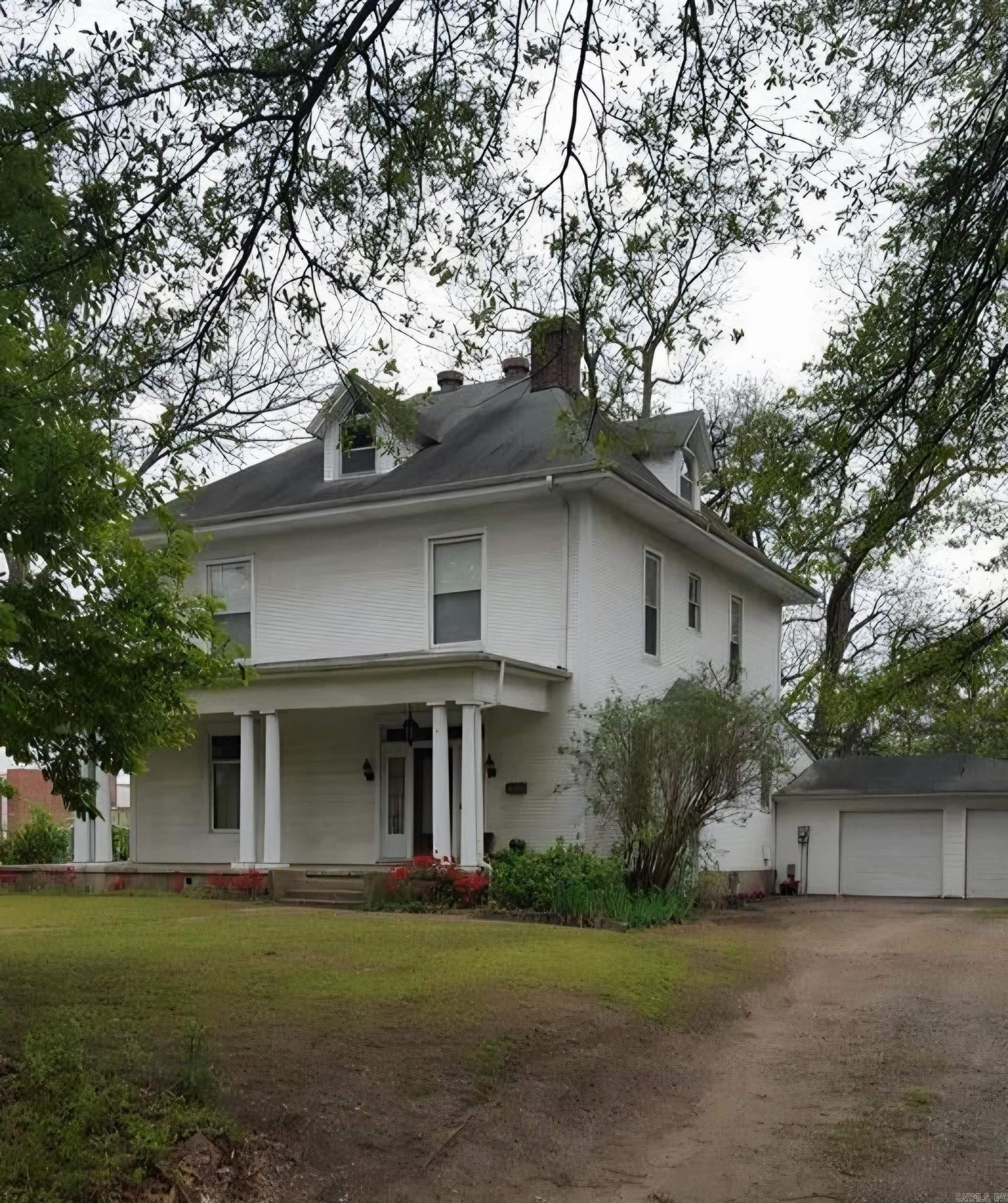 Historic Marion home built in 1911, full of timeless character and architectural Prescence. A stately front porch with classic columns welcomes you into this grand residence. The kitchen has been updated with granite countertops and rich wood cabinets blending modern convenience with original charm. A spacious addition includes a sunroom, breakfast area, full bath, laundry room and huge attached garage.  Upstairs, the bath features a clawfoot tub that highlights the homes period details. with solid construction and great bones throughout, this historic gem is ready for someone with vision and a little TLC to bring it to its full potential.