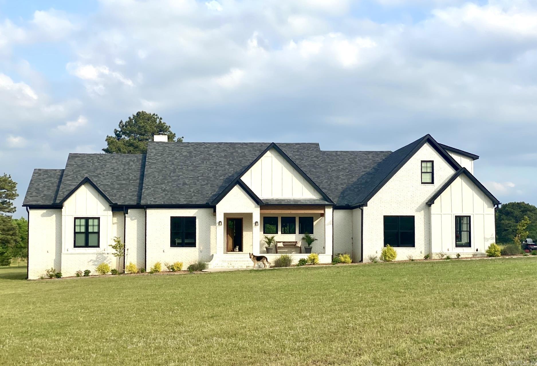 Welcome to peaceful country living with all the modern comforts in this stunning home built in 2018! Situated on 21.98 beautiful acres just outside the Searcy city limits with 3,029 square feet, this thoughtfully designed home features 4 bedrooms and 3.5 baths, with one bedroom currently serving as a spacious home office. The heart of the home is the incredible open living, kitchen, and dining area where large windows showcase breathtaking views of the surrounding property. Warm Saltillo tile, rich hardwood flooring and stylish finishes create an inviting atmosphere that feels both elegant and relaxed. The oversized primary suite is a true retreat featuring a luxurious spa-like bath with a soaking tub, expansive walk-in closets, and plenty of space to unwind. Two of the additional bedrooms each offer their own private bathrooms, providing comfort and privacy for family or guests. The oversized laundry room is exceptional with abundant storage and a convenient dog wash station. Additional features include a safe room located in the oversized two-car garage and a newly added 30x30 barn with tack room and 3 stalls. Welcome to your dream home with room to roam!!! See REMARKS!