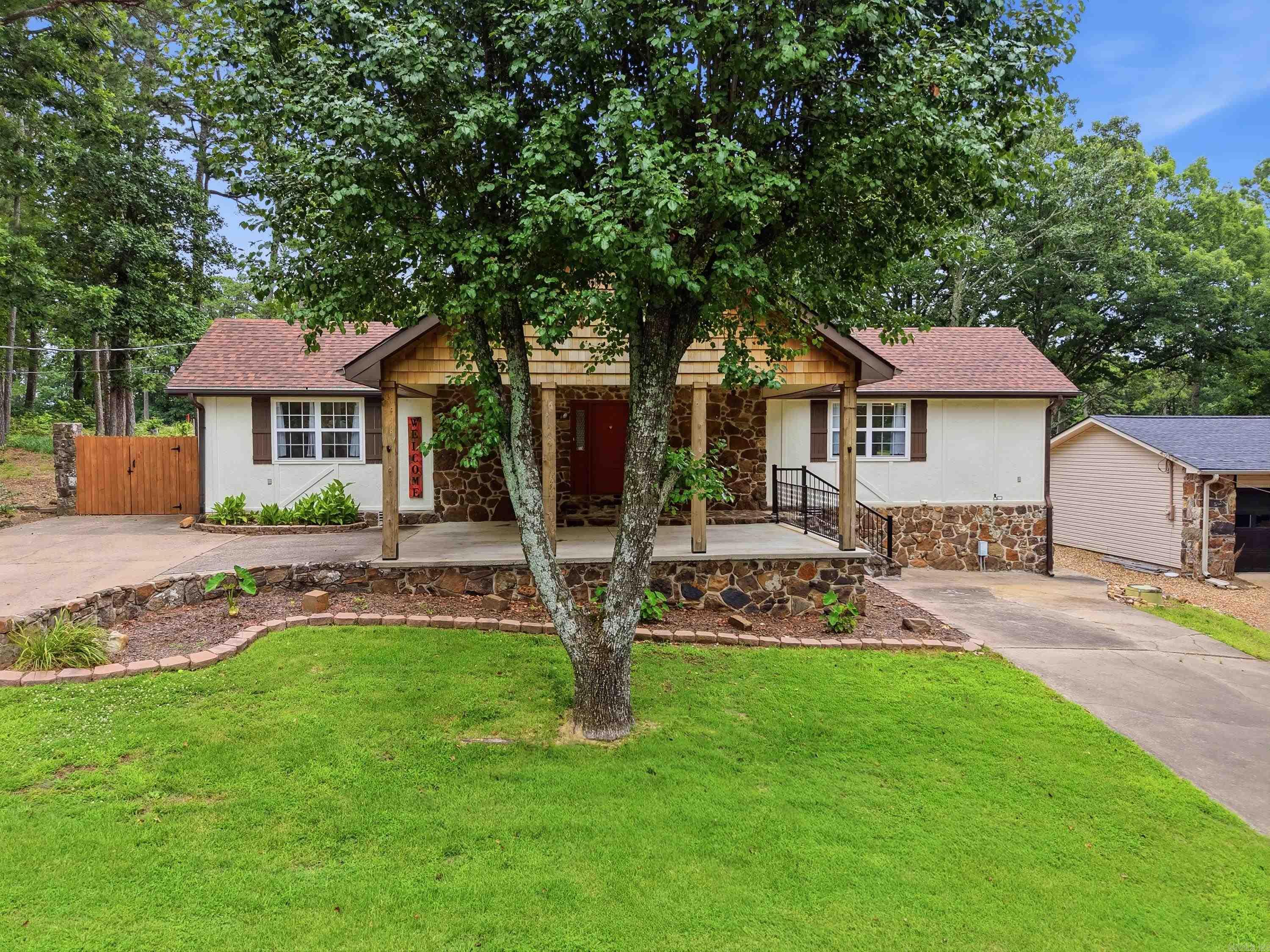 Welcome to 313 Snead Dr. in Fairfield Bay, perfectly positioned on the Indian Hills Golf Course halfway down the fairway of Hole #10! This beautifully remodeled 3 bedroom, 2 bath home offers incredible golf course views and direct backyard access for your golf cart, making it easy to pull straight in from the course. Over the past few years, this home has been completely updated with major improvements including a new HVAC system, mini-split unit, new roof, new windows, and a fully replaced electrical breaker box. Additional upgrades include fresh interior and exterior paint, new chain-link fencing, hardwood flooring in the living room and new carpet. Step inside to an open floor plan w/ vaulted ceilings and abundant natural light, creating a bright and welcoming atmosphere. Multiple sitting areas provide the perfect space to relax and enjoy the golf course views, while the spacious side deck offers plenty of room for entertaining. For added convenience, the washer, dryer, and refrigerator convey with the sale.This move-in-ready golf course home truly has it all; location, upgrades, & lifestyle. Don't miss your chance to own a prime Fairfield Bay property just minutes from the lake