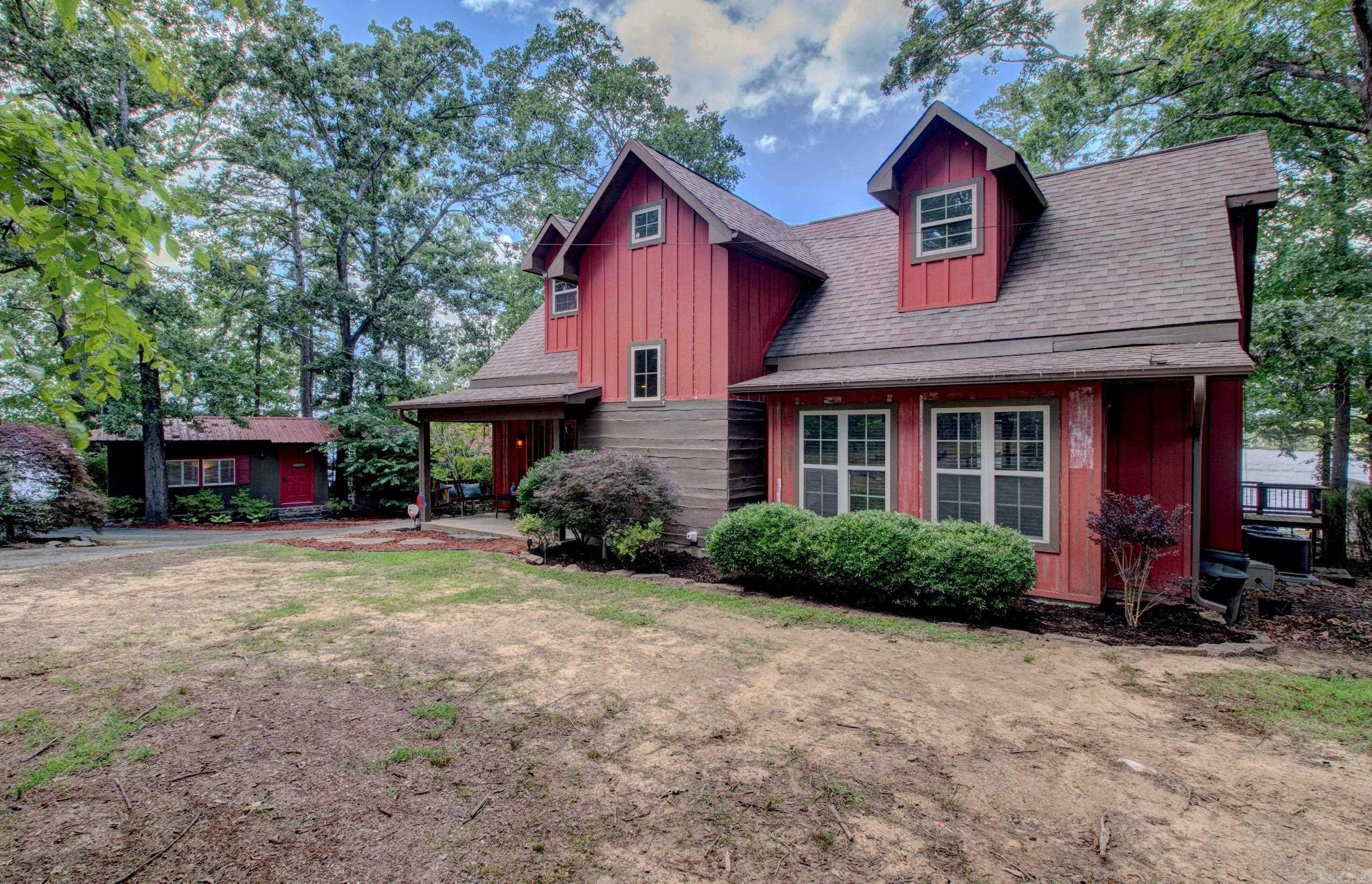 Beautiful Lakefront Home with 2 income producing guesthouses! This stunning 4 bedroom, 2-bath home offers sweeping views of Greers Ferry Lake, positioned along a low white line with its own private tram to the water. The open-concept layout features a split floor plan, a large upstairs bonus room, beautiful flooring throughout, and a wood-burning rock fireplace that adds rustic charm. The kitchen is updated with new granite countertops, stainless steel appliances, a convenient breakfast bar—perfect for entertaining. Master suite boasts lake views, a walk-in closet, an ensuite bath, & direct access to a screened-in porch. Step outside to enjoy the expansive covered porch—ideal for soaking in those lake sunsets. Two additional furnished cabins currently operate as short-term rentals, generating over $26,000 income in 2025. Each cabin includes a bedroom, bathroom, and kitchenette—ready for guests or extra space for family. Both completely remodeled in 2020 & 2021 Whether you’re looking for a private retreat, income property, or both—this is lake living at its best! Neighborhood boat ramp, park, & less than a mile from Laceys marina. Home sold furnished. Agents see remarks!