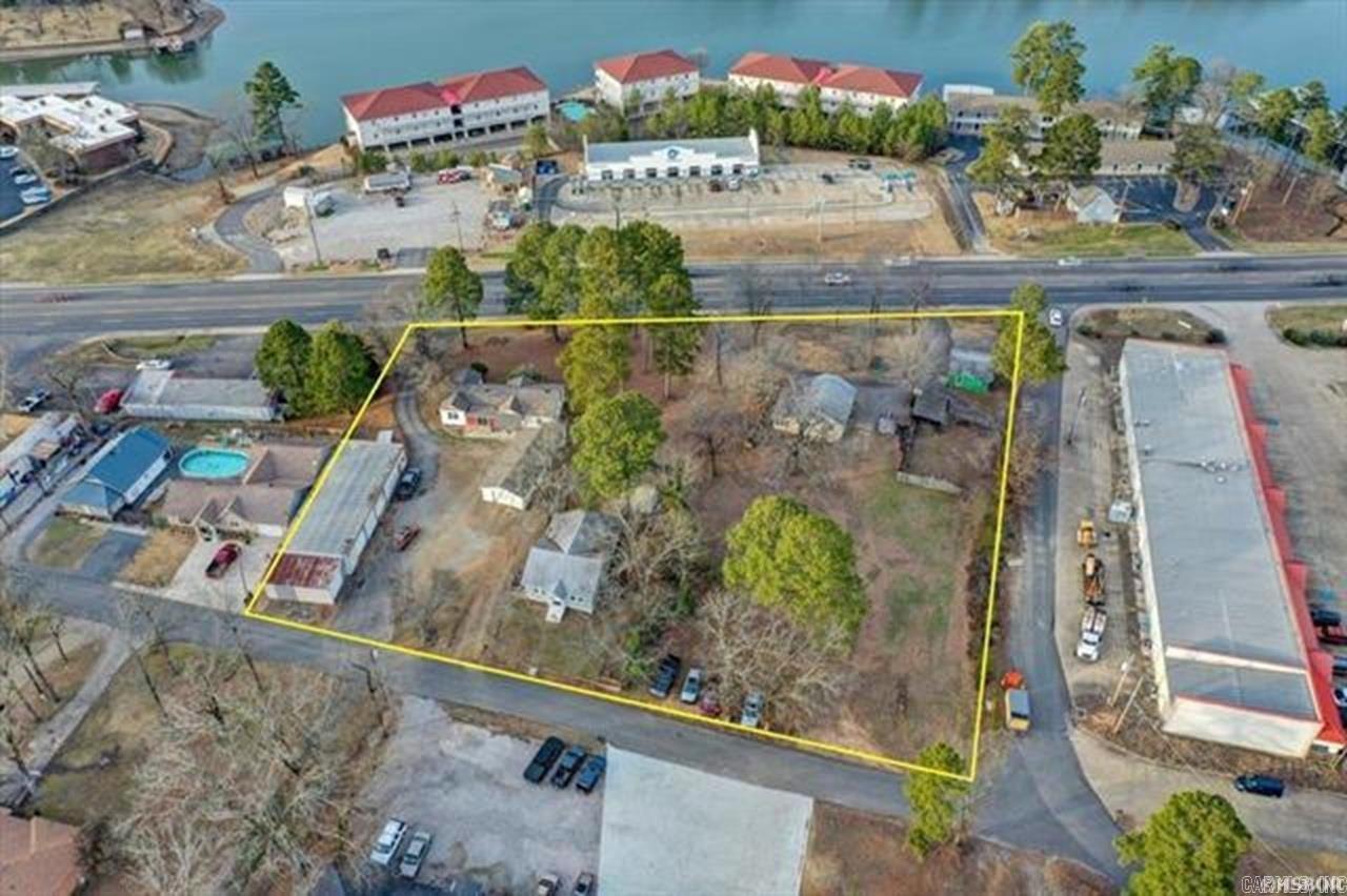 Two occupied homes on the property. One is 3/2, 1395 SF, built in 1958 (1369 Airport Rd) Second is 2/1, 1131 SF, built in 1942 (108Lancaster) However the main value is in the land for commercial development. located just over the 70W bridge. Highly visible with approx. 338ft.+/- of HWY 70W frontage. Surrounded by 3 roads for optimal ingress/egress. Survey on file, 3 parcels total 1.92 acre MOL. Property includes 5 structures (3 homes, small shop, metal building) each with electric, city water, and septic. City sewer is available on Lancaster. 2021 ARDOT Traffic Count of 35,000 cars per day. Convenient to restaurants, shopping, and all Hot Springs has to offer. Being approx. 1 mile from the bypass, there are a plethora of business opportunities awaiting you!