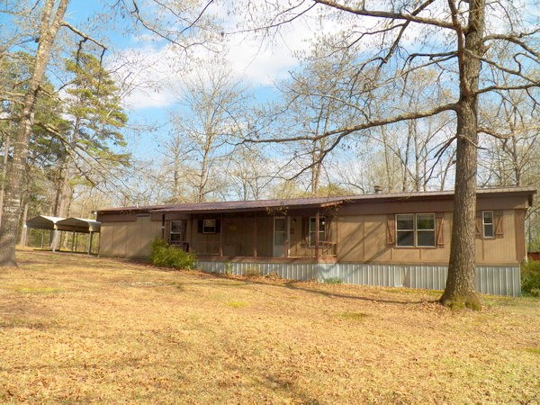 OUACHITA RIVER FRONTAGE.  Walk out front door & a few steps into National Forest, good roads, only 1 neighbor across street.  New roof 2014, new floors in approx 50% of mobile home, large patio partly covered, good FP, Master has tub & shower, 12x24 shop, dry storm cellar .  Covenants & restrictions expired.  See agent remarks.