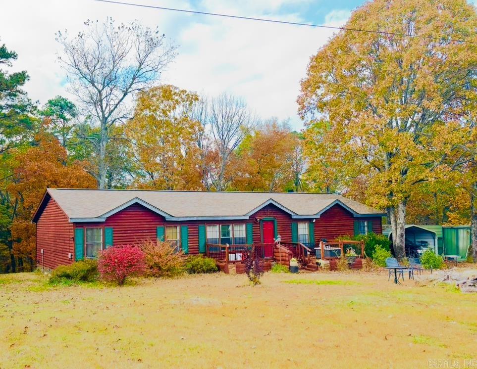Look no more! 3.72 ac MOL off beautiful Banner Mountain Road and scenic AR-16 near Shirley and in close proximity to both Little Red River and Greers Ferry Lake! The log cabin style structure has 3 bedrooms and 2 bathrooms; the primary bedroom being apart with a large ensuite bath and soaking tub.  The kitchen/dining combo is spacious with stainless appliances, laundry room equipped with a stainless washer/dryer set and freezer, plus an inviting family room, a cozy LED fireplace, and double doors leading out to the private covered back porch offering peaceful woodland views and sounds from a wet weather creek. Numerous updates throughout; blinds, fresh paint, bathrooms, laminate and tile flooring, tile countertops. Plus, the lawn equipment and most of the furniture and furnishings convey including wall art, leather furniture, master bedroom set. The house well may not be sufficient year round for a family however Van Buren Co rural public water is available but not yet on the property.  The parcel also has a beautiful building site perfect for a walk-out basement. Barn shed and other outbuildings convey! Call today for more info on this move-in ready home that's priced to sell!
