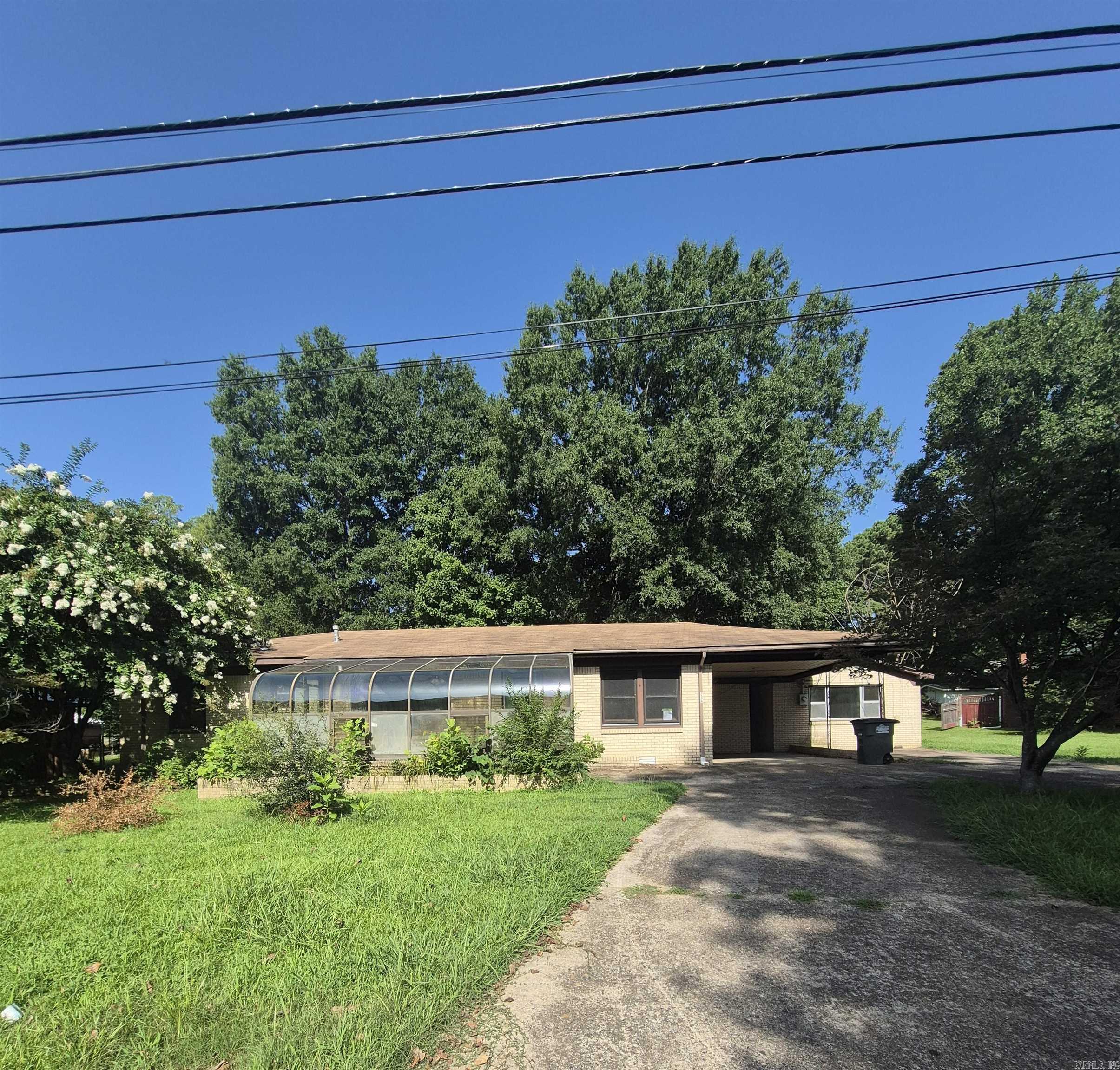This house has a number of bonuses. Room off the kitchen could be an office. Large room off main bedroom has a hot tub and a lot of extra space in there.  Nice back yard for children or pets to roam. For someone with a green thumb, there is an amazing greenhouse on the front of the house.  A picture window in the livingroom overlooks it and is the perfect place to enjoy the fruit of your labor. Spacious kitchen with separate dining room and pass thru window in between. Detached building with all sorts of possibilities.  (Already has water and electricity available.)  Quiet neighborhood.  Convenient to everything. All bids must be made online. HUD Case Number  031-551680. All HUD properties are  sold "as is."   Additional details about the property and how to bid can be found at www.HudHomeStore.gov