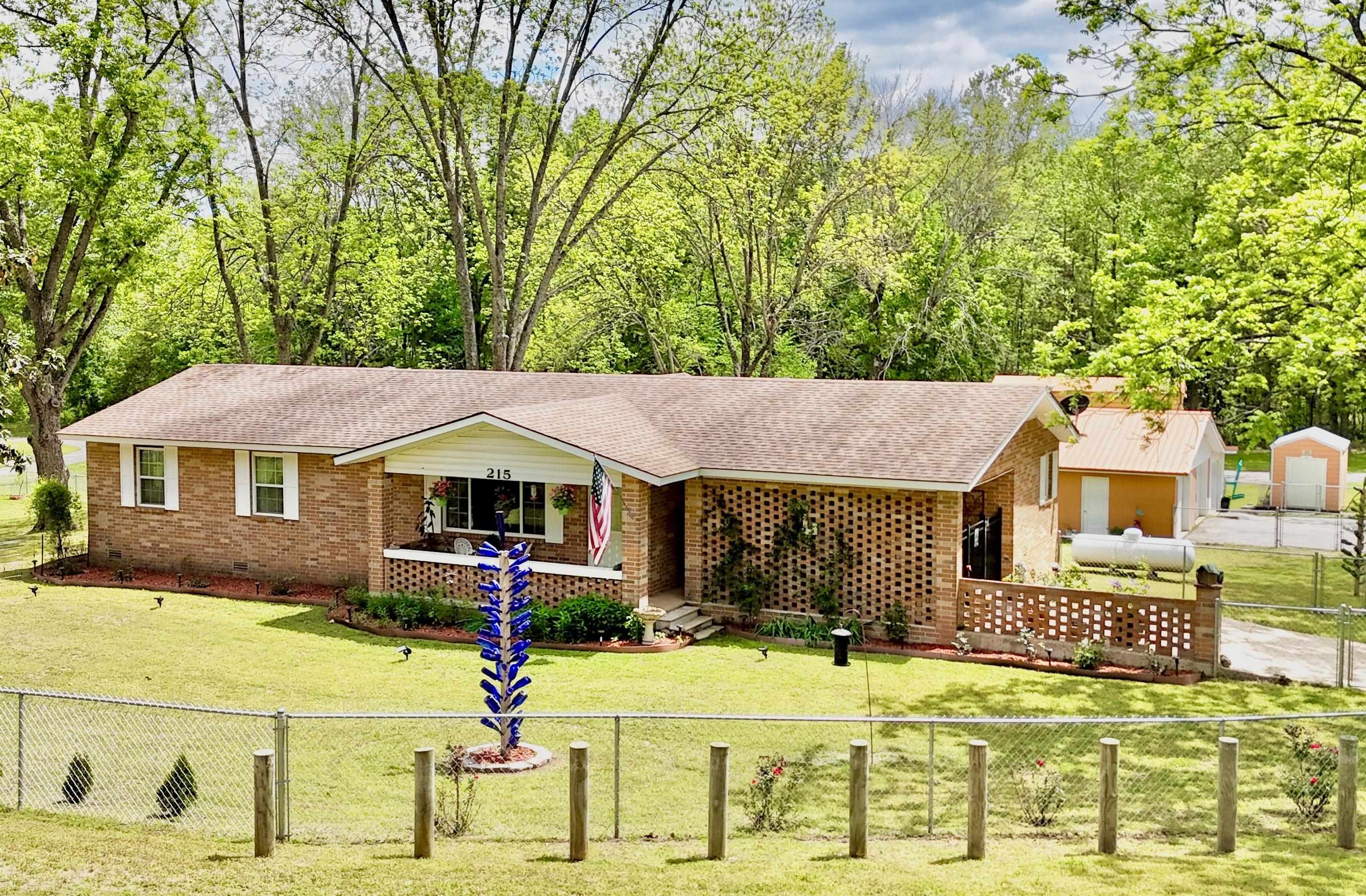 Completely remodeled brick home on 1.33 acres with a true park-like setting! This 3 bedroom, 2 full bath home offers a spacious layout with a large living area and a stunning custom kitchen featuring quartz countertops and a walk-in pantry/laundry room. Every inch of the home has been updated, including electrical, plumbing, HVAC, spray foam insulation, doors, windows, fixtures, jaccuzi tub, & so much more, giving you a fresh, new home feel throughout. Step outside to enjoy a beautifully maintained yard with a fenced-in area, inviting front porch, back patio, a charming courtyard that could easily be converted back into a 1-vehicle carport, grape Vineyard, and pecan, walnut, & fruit trees!  Need space for projects or storage? You’ll love the  1600sqft garage/workshop along with a 16x30 RV covering. All of this sits on a paved road in a fantastic location offering both convenience and a peaceful setting while bordering a year round creek!