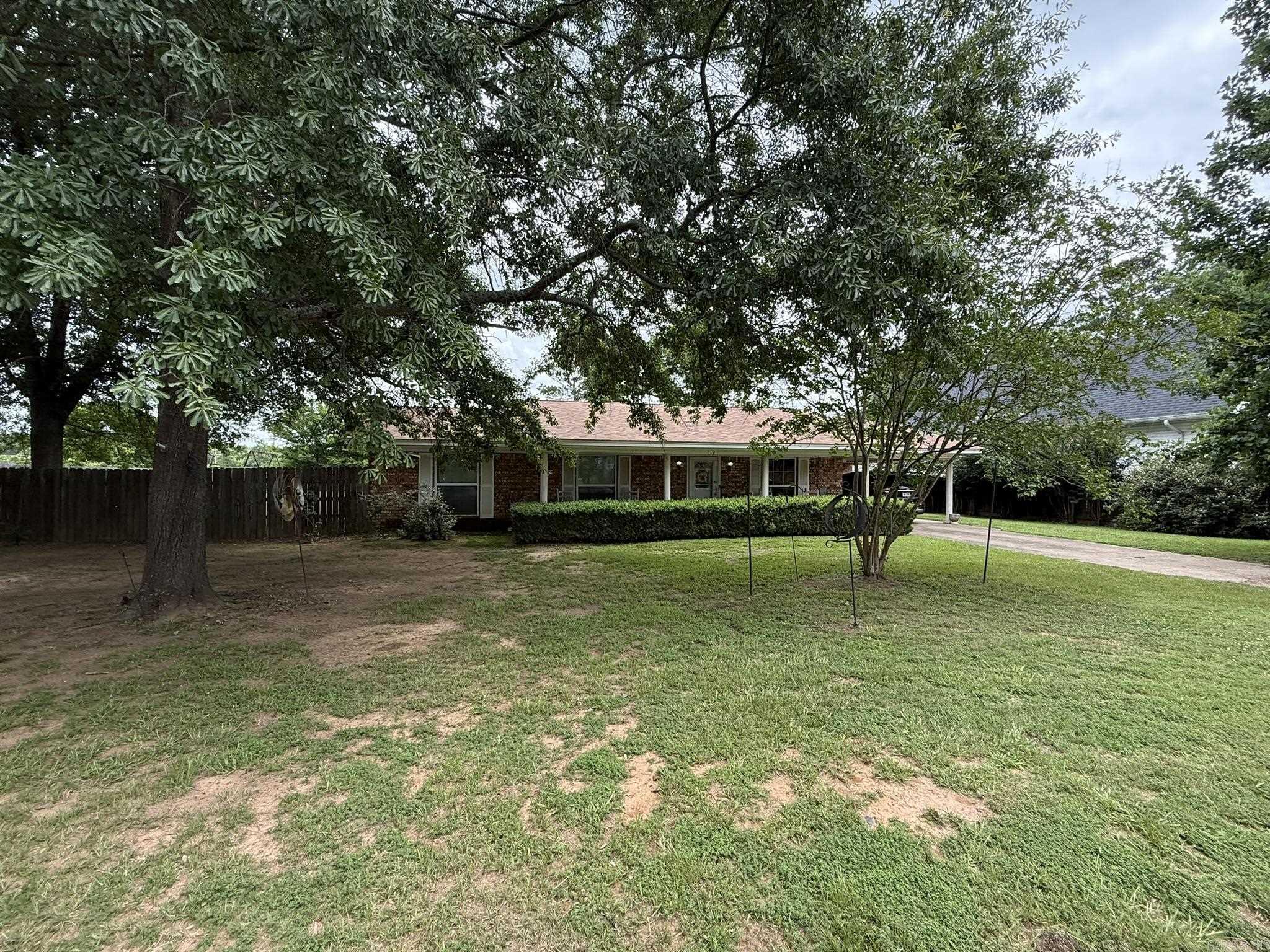 Brick home in the heart of Murfreesboro with in walking distance to the historic downtown square for shopping and eats, minutes from Lake Greeson and the Crater of Diamonds State Park.  This home is move in ready, new roof in 2025, updated bathrooms in 2019 and updated kitchen.  3 bedrooms and 2 full baths, open concept living/dining, kitchen includes refrigerator, stove and dishwasher, breakfast bar, and laundry area.  Covered patio, storage shed and fully wood privacy fenced backyard.  CH/CA, gas hot water heater, storage room and single carport.  Contact our office for more details or to schedule a private tour.