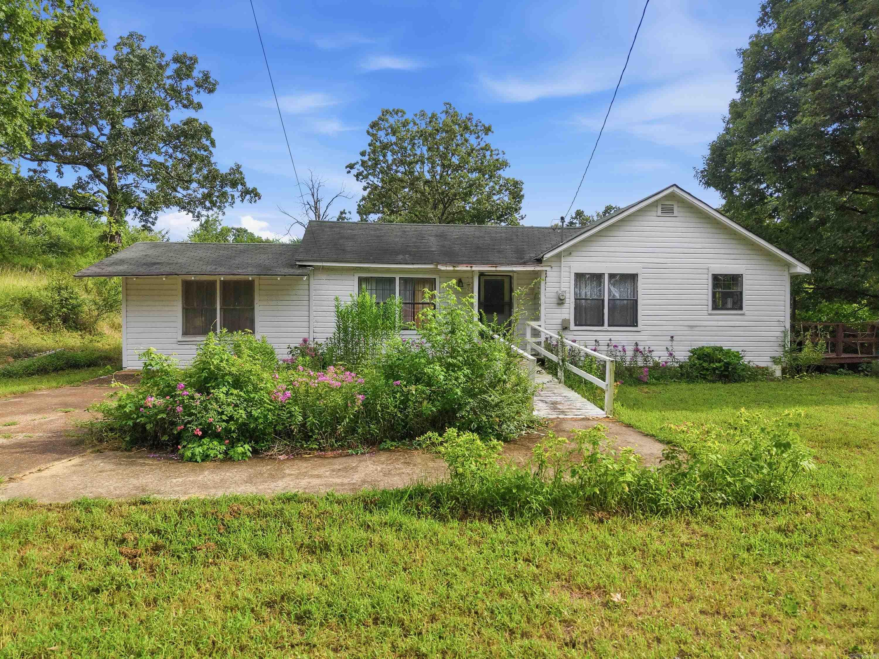 This property has been in the same family for many years and is ready for its next chapter. Situated on approximately 9 unrestricted acres with a pond, it offers a country setting just outside the city limits while still providing convenient access to town. The 3-bedroom home is a fixer-upper and is being sold in need of repairs, making it an excellent opportunity for buyers looking to renovate. With no restrictions, the property offers flexibility for a variety of uses, whether you're searching for a primary residence, a rental or investment property, or simply looking for acreage with room to grow. The land provides space for gardening, livestock, recreation, or future improvements, and the pond is an added feature to enjoy. Bring your vision and restore this longtime family home into a place where new memories can be made.