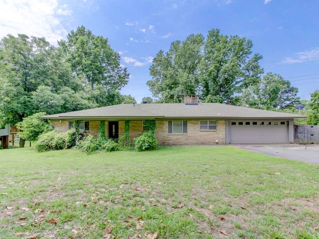 Remarkable Location with Brick 3-2-2 with two living areas, kitchen/dining combination room, large 1.92 AC fenced lot leading down to lake living with waterfront lot 218 ft. of water frontage bulk-headed but no boat dock on property. This home can be remodeled or you can demolish and build your dream home.  If you are dreaming of a lake home in an established area with mature trees and large estate sized lot, this is it!