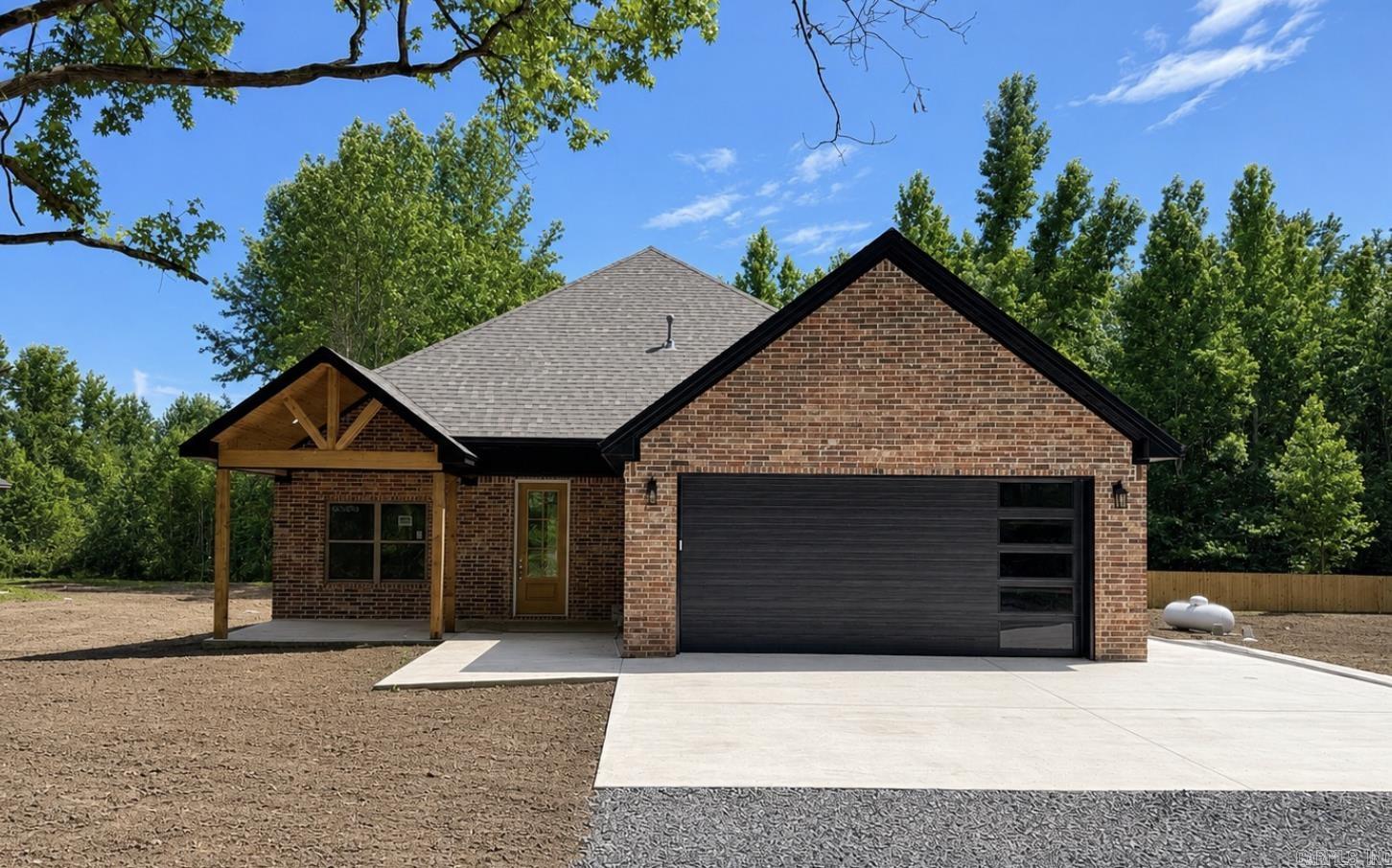 Check out this beautiful new construction just outside of Cabot! Featuring 3 bedrooms, 2 bathrooms, vaulted ceilings, and an open-concept floor plan, this home is designed for comfortable living. The spacious kitchen offers a gas range and a large pantry, while the cozy gas fireplace creates the perfect gathering space. The primary suite features a beautiful tile walk-in shower, and both the covered front porch and back porch provide great places to relax. Out back, you'll enjoy peaceful views of natural foliage—all while being just minutes from town and conveniently located right off Highway 5. (more photos being uploaded soon)