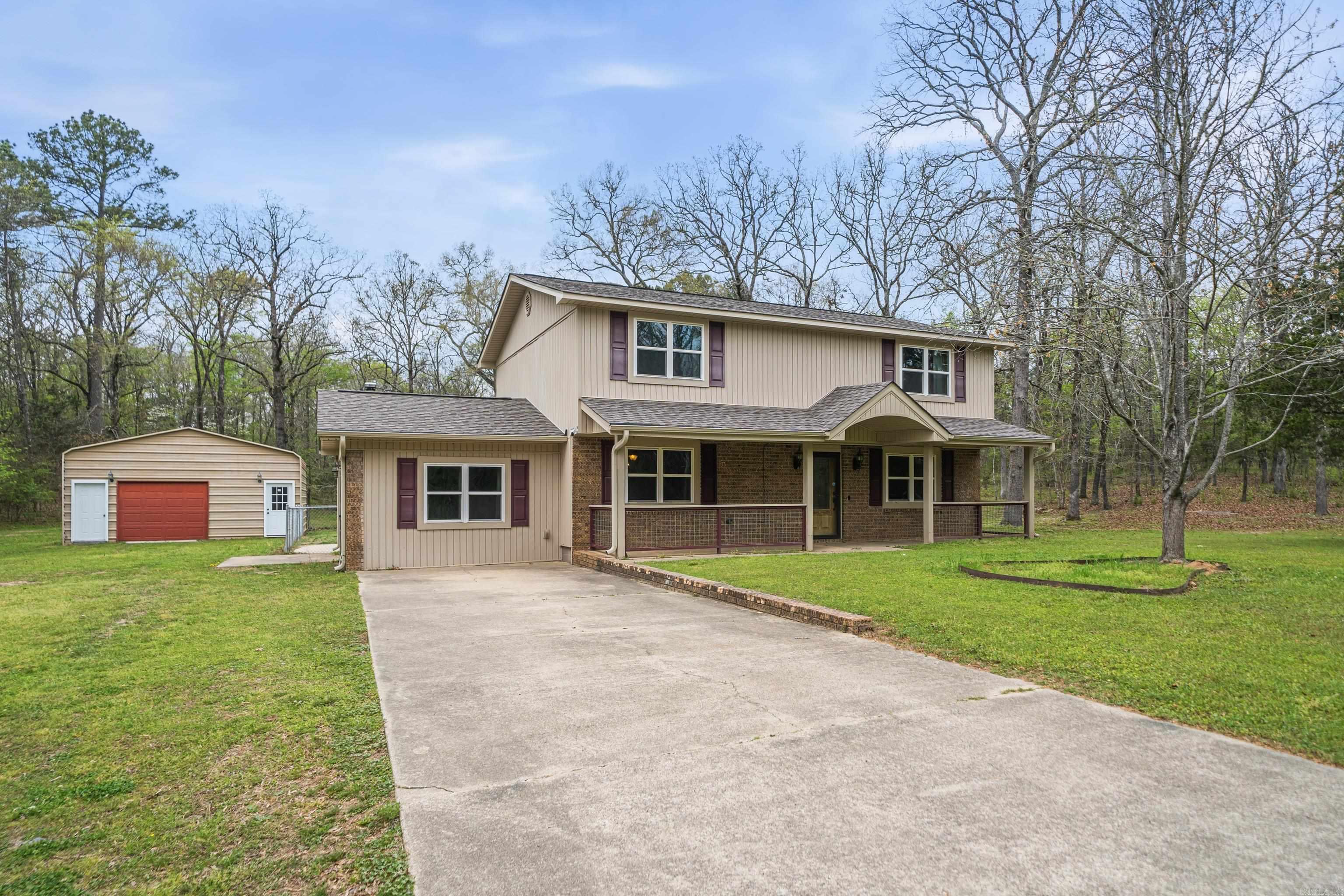 Welcome to this charming 2-story home nestled on a spacious 1.17-acre lot, with perfect blend of comfort, functionality, and updates. This well-maintained property features 4 bedrooms, 2 full baths, and 1 half bath.  Beautiful hardwood floors add warmth and character throughout. The den offers a cozy space to relax, while the homey kitchen is perfect for preparing meals and gathering with family. A separate dining room provides an ideal setting for hosting dinners and special occasions. Step outside to enjoy the welcoming front porch—perfect for morning coffee or unwinding in the evening.  Upstairs, is the spacious primary suite complete with an ensuite bathroom and its own deck access. The additional 2 bedrooms are well-sized and provide flexibility for family, guests, or a home office.  Siding, roof, and water heater are all approximately 4 years old, while the patio was added just 3 years ago—creating a great outdoor space for entertaining or relaxing.  Brand-new HVAC system, updated thermostat, and new breaker box added for improved efficiency and reliability.  The expansive 1.17-acre lot offers plenty of room to enjoy the outdoors, with two storage buildings.