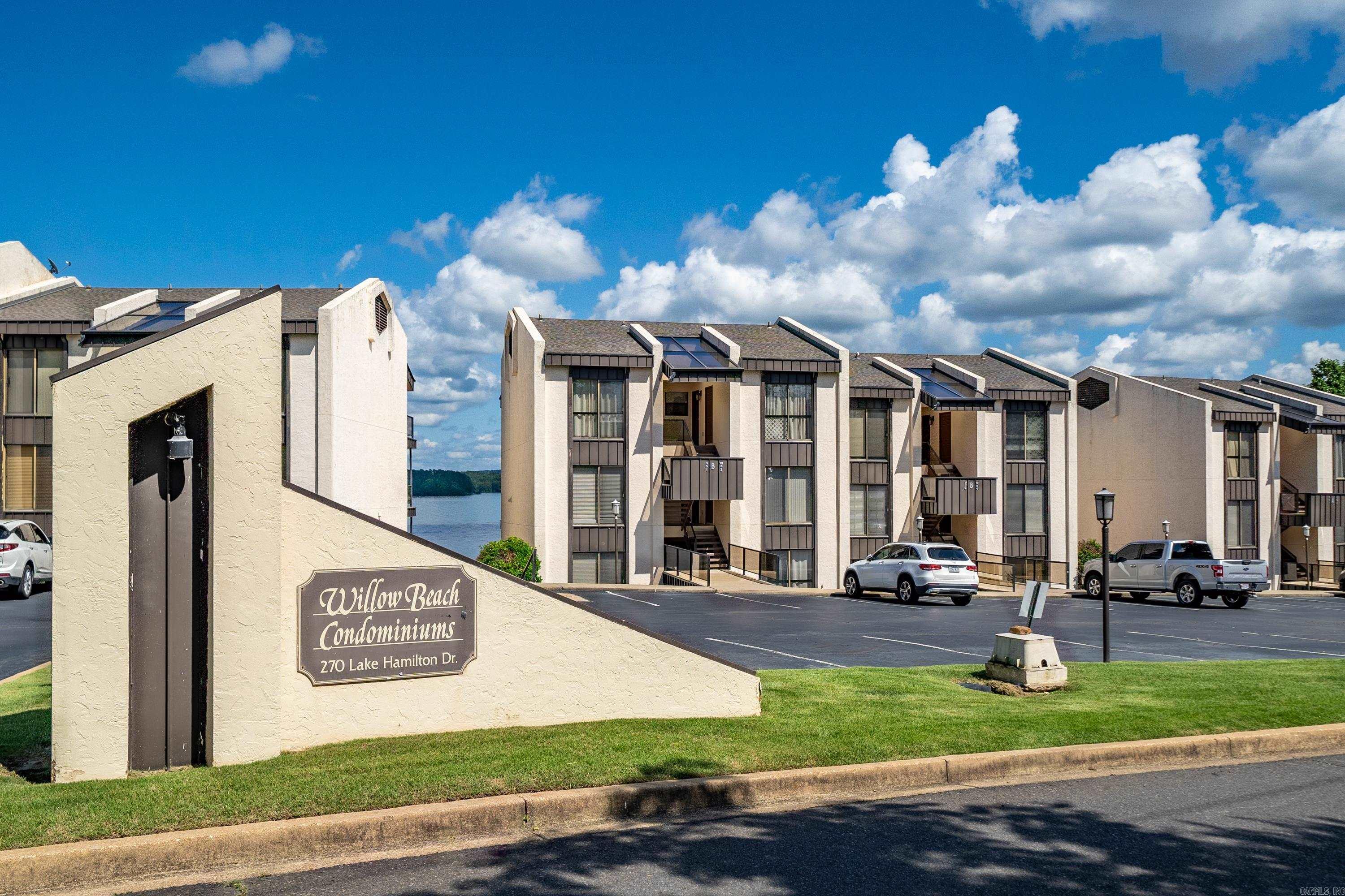 Welcome to lakefront living at its finest! This stunning 1-bedroom, 1-bathroom condo at Willow Beach comes fully furnished with brand-new appliances and offers breathtaking, unobstructed views of Lake Hamilton and the surrounding mountains. Centrally located in Hot Springs, you are just minutes away from premier shopping, dining, and entertainment! Whether you are looking for a turnkey personal getaway, a full-time residence, or an investment opportunity, this unit fits the bill—short-term rentals are permitted here! The property comes complete with highly coveted perks, including a 1-stall boat slip and a covered parking spot. Incredible community amenities feature a sparkling in-ground swimming pool overlooking the lake, a relaxing sauna, and an on-site laundry facility. Don’t miss your chance to own a move-in-ready slice of paradise with some of the best views on the lake!