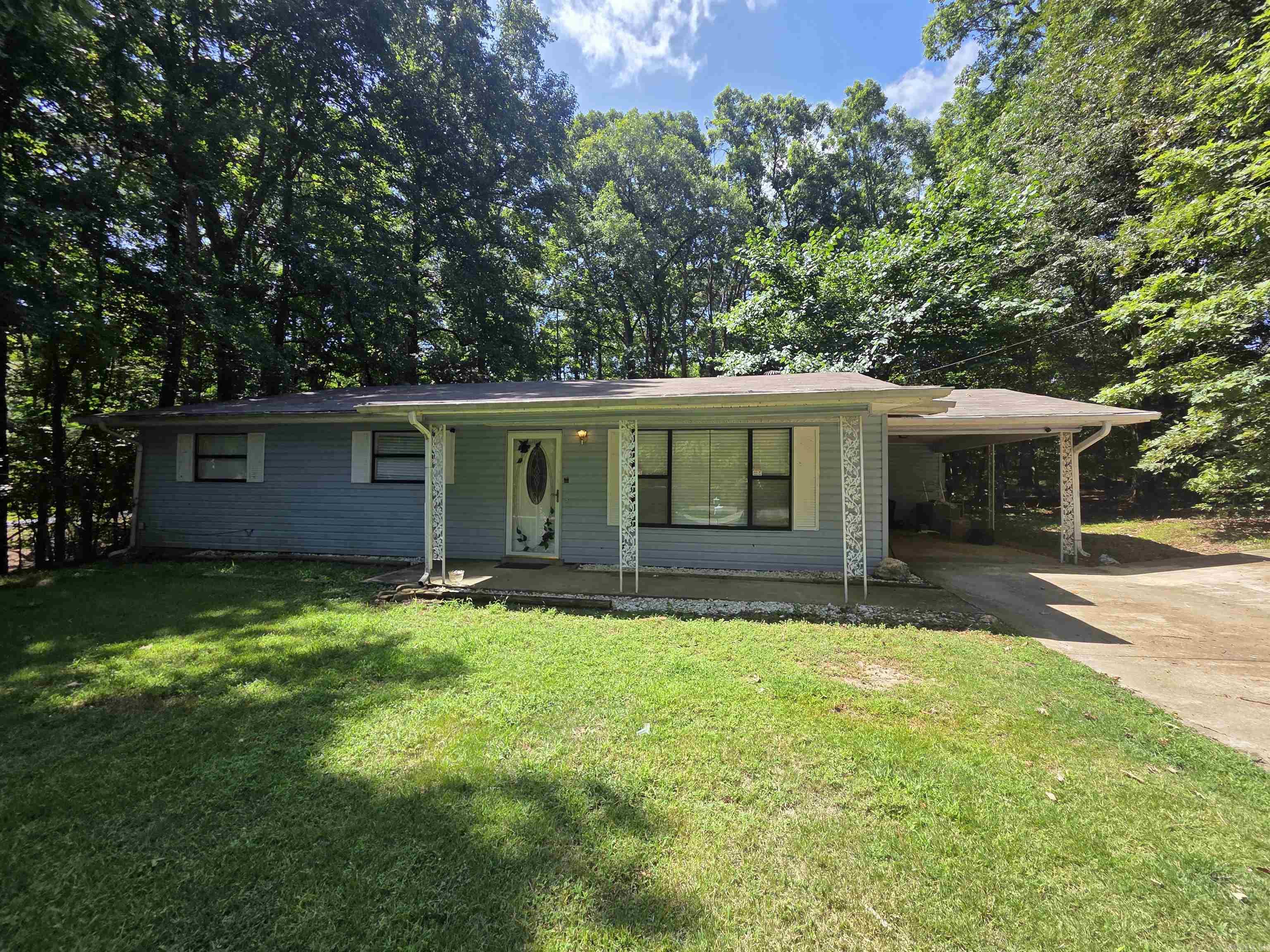 CHARMING & UPDATED RENTAL IN GATED DIAMONDHEAD! This beautifully modernized 3 BR / 2 BA traditional home sits on a private 0.83-acre wooded corner lot, offering a peaceful country-living feel with premier resort perks. Enjoy a bright, open-concept kitchen, living, and dining space featuring updated quartzite countertops, stainless steel appliances, a breakfast bar, and a spacious pantry. Energy efficient with a new roof (2023) and new HVAC (2024).  Includes carport parking, laundry room, and separate workshop/craft space. Pets allowed with a non-refundable pet deposit.