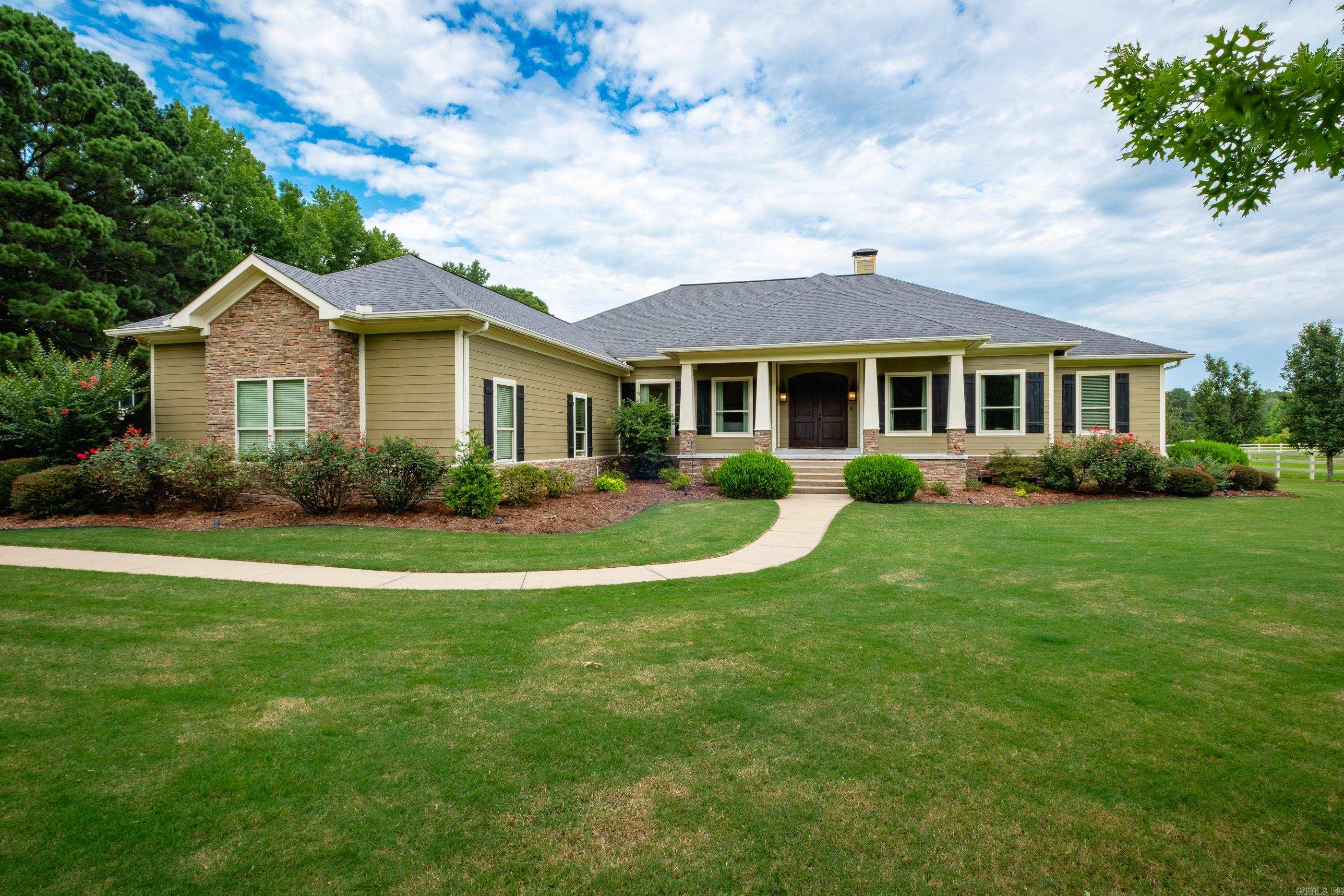 Exceptional custom home on 2+ acres with a thoughtfully designed floor plan that makes everyday living and entertaining effortless. Warm architectural details including wood beams, graceful arches and beautiful flooring create character throughout. The foyer opens to the spacious great room with a fireplace and built ins, flowing seamlessly into the well equipped kitchen with a large island, gas cooktop, double ovens and walk in pantry. The dining room just off the kitchen is surrounded by windows overlooking the covered patio, pool and backyard. The one level layout includes a private primary suite, guest suite, and two additional bedrooms with a shared bath featuring separate vanity areas. A media/game/fitness room with built in cabinetry offers flexible living space, while the powder bath has direct access to the backyard spaces. A bonus room over the garage with walk in attic storage is perfect as an office, playroom or hobby room. Outside, enjoy the covered patio with outdoor kitchen, sparkling pool and expansive lawn. Completing the property are a 3 car attached garage with shop sink and storage and an oversized detached 2 car garage with two large storage rooms. Come see!