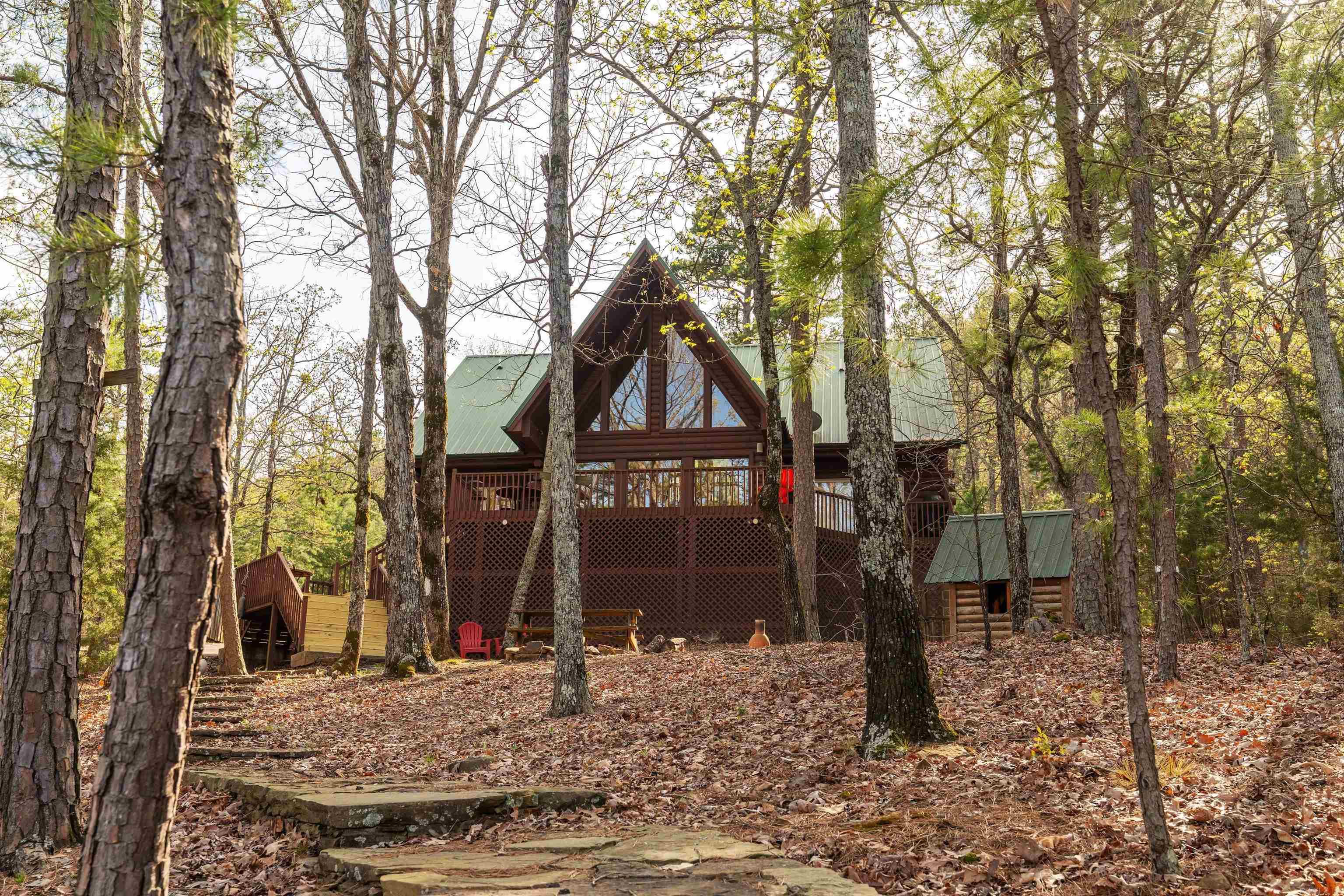 Experience the best of Greers Ferry Lake living in this inviting 4-bedroom, 4 bath log-style lake home. Designed with both comfort and entertaining in mind, the home features a spacious living area with vaulted ceiling and windows that frame beautiful lake views. A large lakeside deck provides enjoyable outdoor living space, perfect for relaxing or hosting guests. The lakefront lot features excellent white line frontage and includes a Corps of Engineers-permitted private path to a beach shoreline. A garage offers convenient storage for lake toys and equipment. **Furniture included with the price of the house (with the exception of few of the sellers' items).