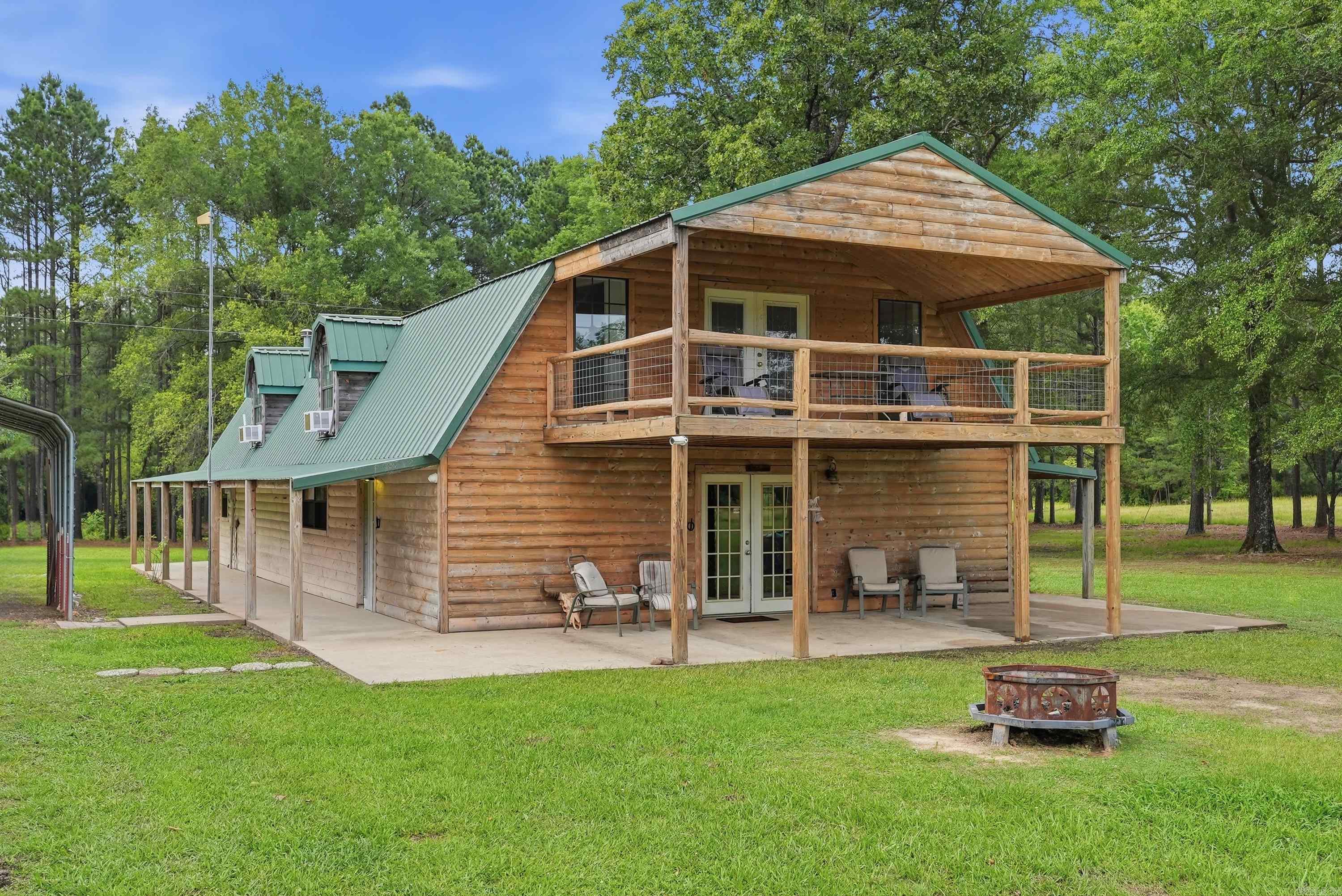 Welcome to this unparalleled rural retreat on over 80 acres of versatile Arkansas land. Whether you are looking for an expansive estate, a premier hunting property, or a special events locations, this stunning acreage delivers on every front. The main floor provides 1800sqft with both bedrooms, nicely updated bathroom, over-sized utility room, and open living space, which offers one of a kind features such as cedar post and reclaimed wood paneling. Upstairs is 1320sqft of freshly completed open living space opening to the large cover deck overlooking the beautiful property. The land offers excellent hunting for turkey and deer, stocked ponds, fields of hay, and even space for future building with utilities already available. This is your opportunity to own a rare, all-encompassing piece of private Arkansas paradise!