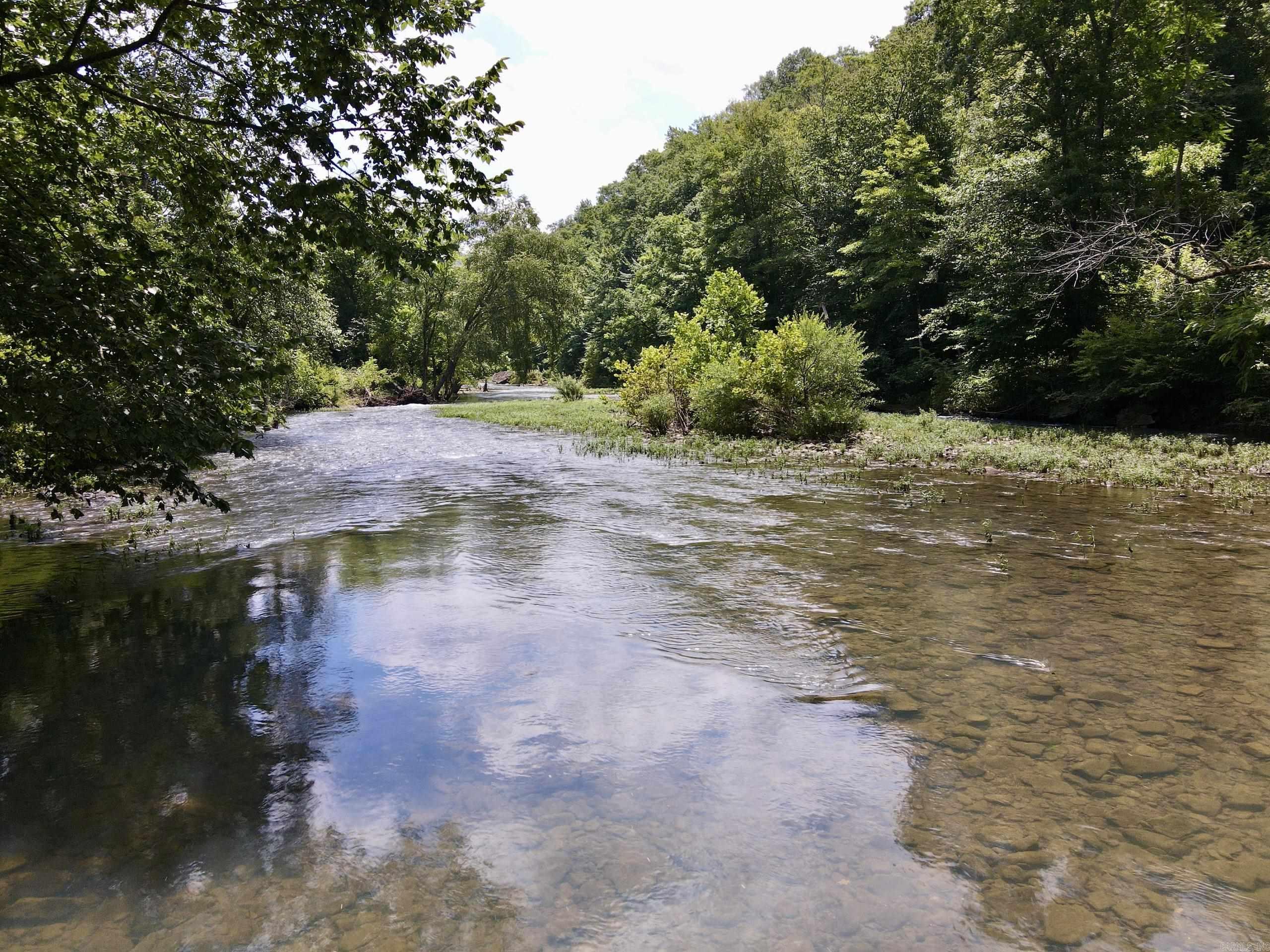 Bordering the Ozark National Forest, this exceptional Ozark Mountain property offers privacy, stunning scenery, and outstanding recreational opportunities. Located on a county-maintained road with electricity and high-speed internet available, it features multiple premium building sites ideal for a custom home, cabin, vacation rental, or family retreat.  Just minutes from Big Piney Creek, Richland Creek Wilderness, Pedestal Rocks, Haw Creek Falls, Piney Creek WMA, the Ozark Highlands Trail, and Carwash Falls, the property provides easy access to kayaking, fishing, hiking, camping, horseback riding, mountain biking, and more.  The land is mostly open with mature timber along Big Piney Creek, creating excellent habitat for whitetail deer, wild turkey, black bear, and bald eagles. With county road frontage, utilities, National Forest boundary, multiple homesites, and exceptional recreation, this property is ideal for a private estate or investment.