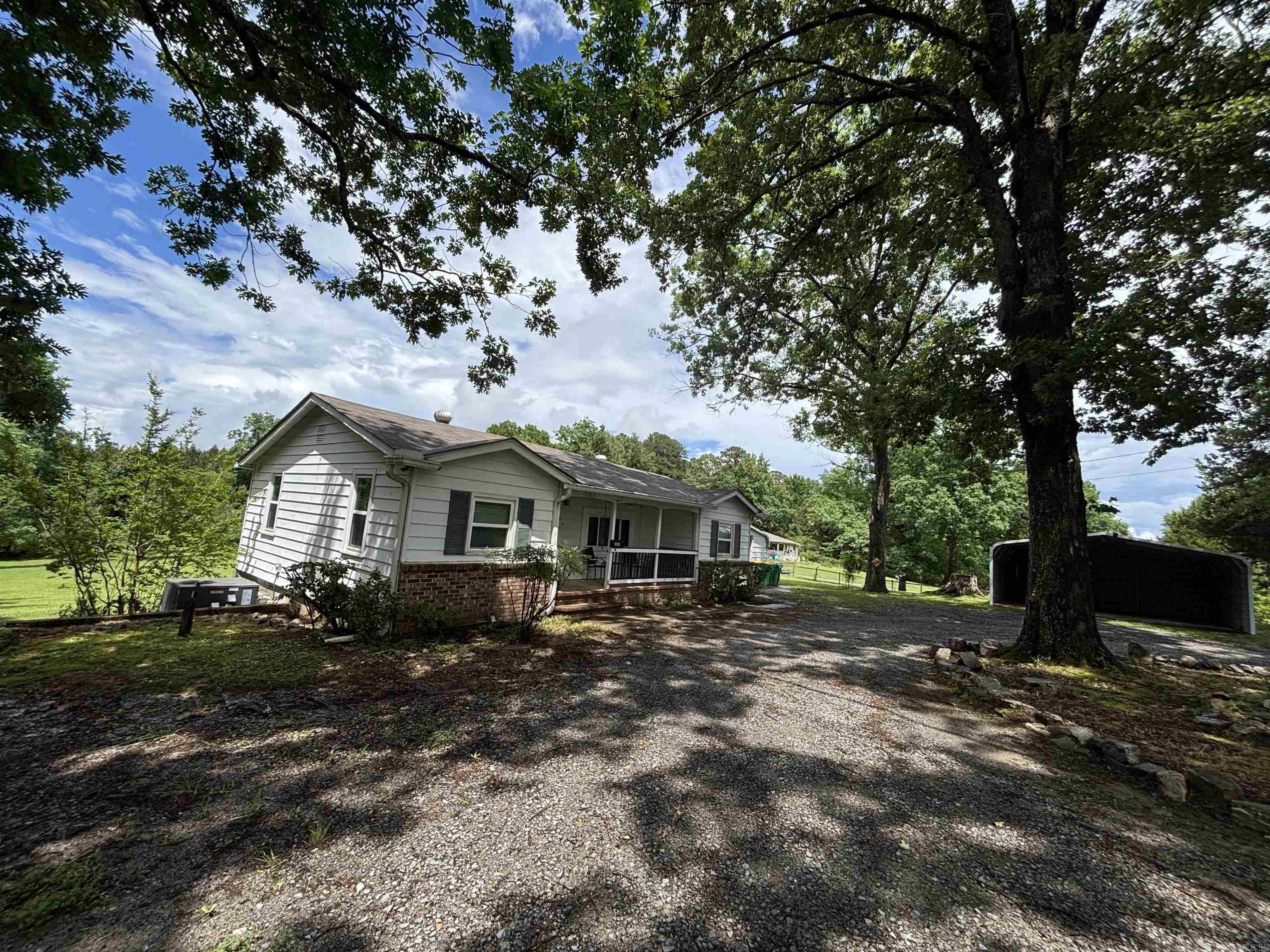 This is a charming little home with 3 bedrooms and 1 full bathroom. This home has 2 beautiful acres with it. 10x11 enclosed sunroom. 2 car carport and shop with mini split. This home has had previous foundation issues. It does not need some TLC but it is believed the foundation issues have been previously resolved.  REALTORS SEE REMARKS BEFORE SUBMITING OFFER.