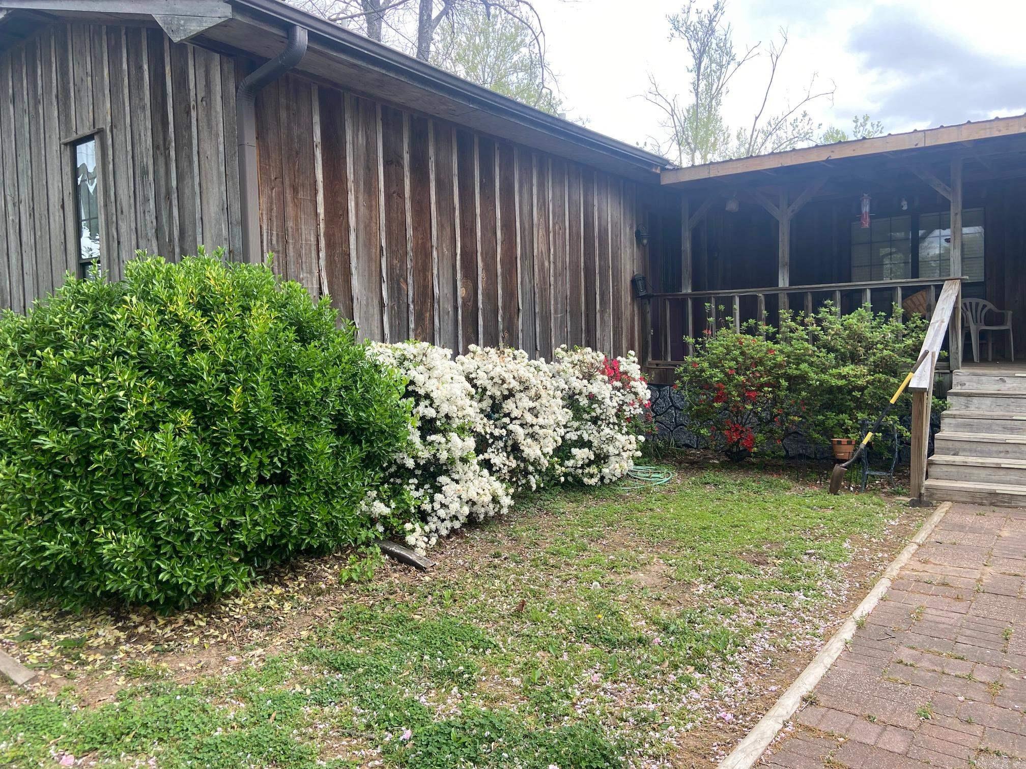Beautiful waterfront home on a quiet dead-end road with direct water access and a large dock for boating and fishing. All bedrooms are located upstairs with 3 full baths, plus an additional full bath downstairs. The upper level sits above flood level with a current elevation certificate.  Home features two living areas, ideal for entertaining or flexible use. Recent updates include new HVAC (2023), new front and back staircases, and a built-in microwave and garbage disposal. Kitchen includes stove, refrigerator, and dishwasher.  Two master suites, with one bath under remodel—materials to complete will convey. Large pantry with washer/dryer hookups upstairs.  Exterior offers a fenced backyard with large and small gates, mature hedges and azaleas, garden area, and a covered front porch with privacy hedge. Garage downstairs has front and rear access with automatic openers, plus interior and exterior stair access.