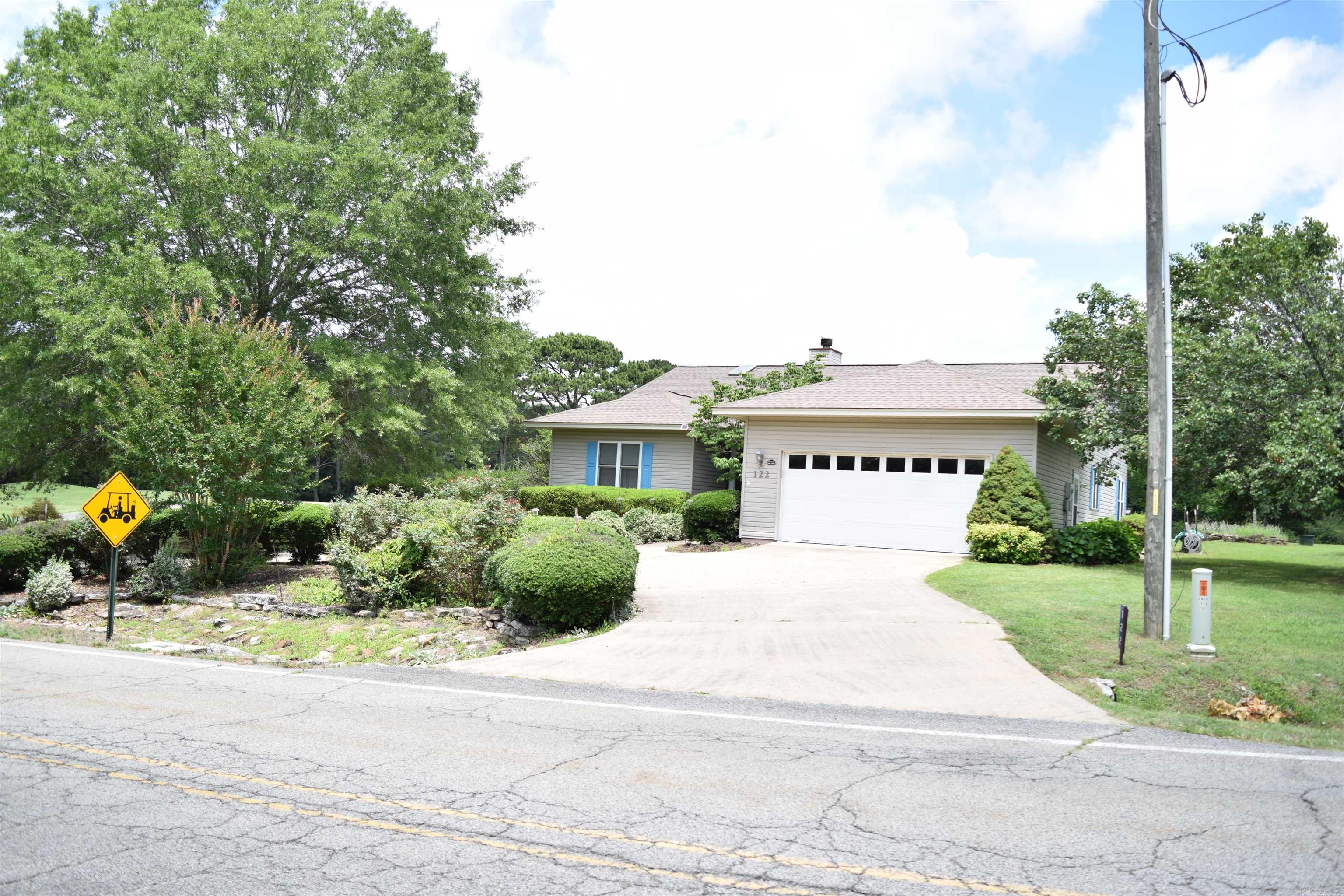 Enjoy peaceful golf course living in this well-maintained 1,788-square-foot home situated on the desirable 15th green. This inviting residence features 2 bedrooms and 2 bathrooms, with vaulted and high ceilings throughout that create an open, airy atmosphere filled with natural light.    The spacious floor plan includes a bright sunroom overlooking the golf course, providing the perfect space to relax, entertain, or enjoy your morning coffee. Step outside to the patio, where you can take in beautiful views of the fairway and surrounding landscape.    Recent upgrades include newer energy-efficient windows and sliding glass doors, complemented by custom blinds that enhance both comfort and style. The home offers a tasteful combination of partially hardwood flooring and other easy-care surfaces throughout the living areas.    Additional features include a golf cart garage, ideal for golf enthusiasts and extra storage needs. With its attractive location, thoughtful updates, and comfortable living spaces, this home presents an exceptional opportunity to enjoy golf course living at its finest.