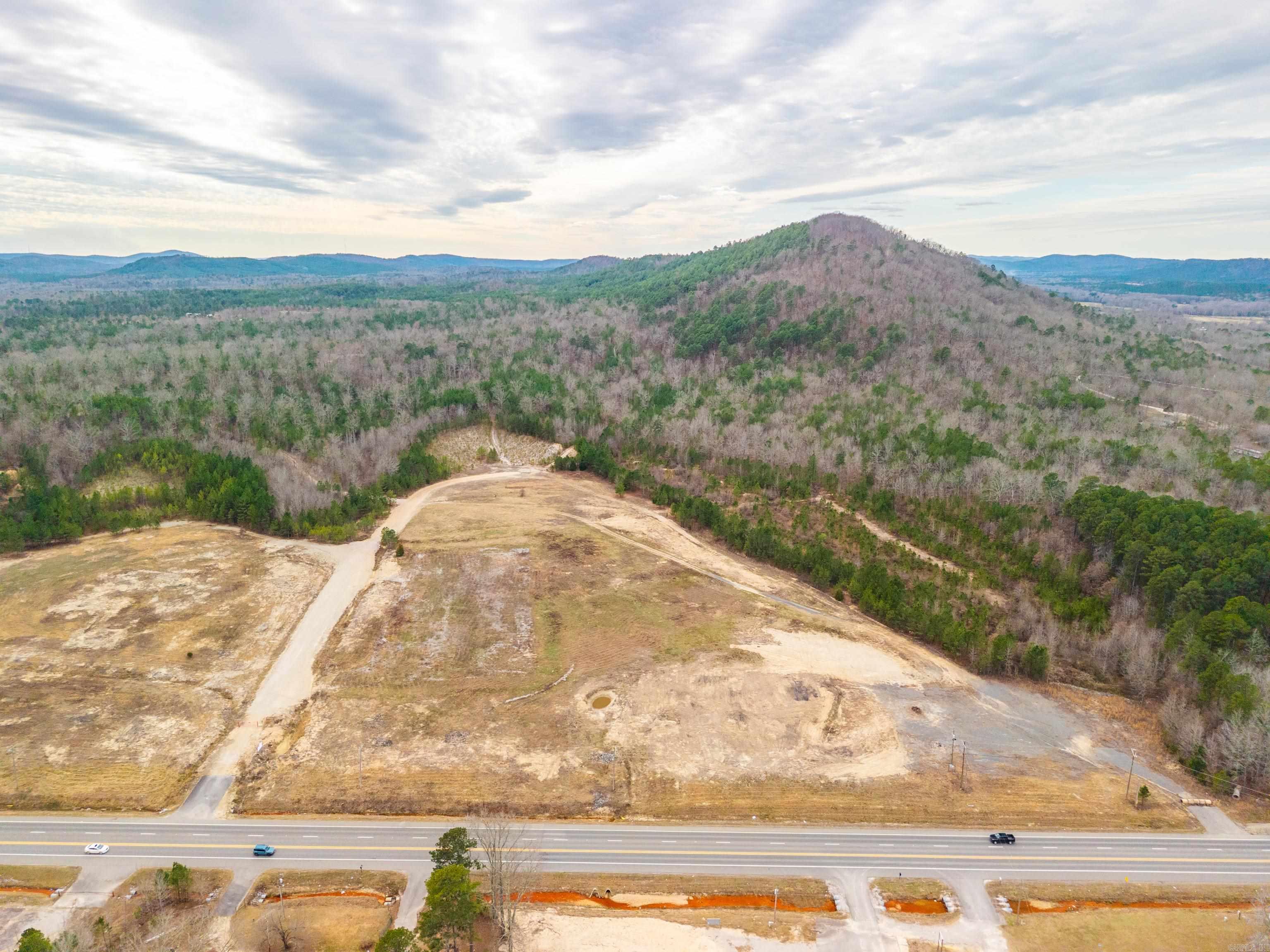 Approximately 199 acres of land, will possibly subdivide. 37.08 acres with approx 2288 ft of frontage on N Hwy 7 is flat, ready to build, and excellent for commercial development, with 25.22 acres directly behind. The remaining 136.77 acres would make a fantastic residential development with a preliminary plat already prepared with 15 lots. Lot sizes vary between 3.24 acres and 23.63 acres There is also approx 2186 ft of frontage on Goathill Rd. Electric, water and gas available.