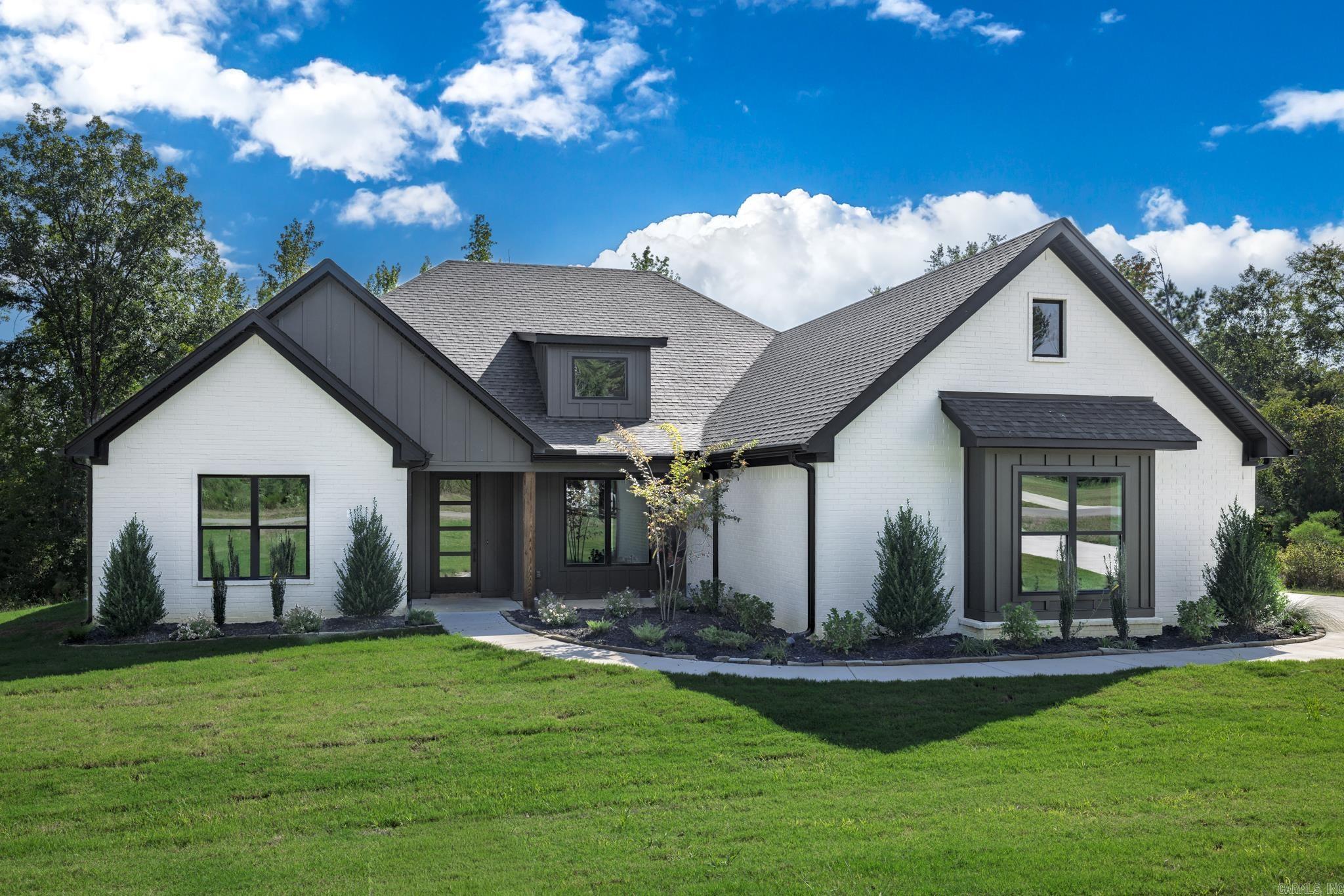 This stunning new construction home in the beautiful North Ridge Estate, just outside of Arkadelphia, offers the perfect blend of style and function. Featuring four spacious bedrooms and three bathrooms, this home boasts an open-concept living, kitchen, and dining area designed for entertaining and everyday living. The kitchen offers tons of counter space, a massive walk-in pantry, and a layout that makes meal prep effortless. The luxurious primary suite includes a large soaking tub, oversized shower, and separate his-and-hers walk-in closets. The guest bedrooms are connected by a convenient Jack-and-Jill bath, providing both privacy and practicality. Outside, you’ll find extra landscaping that enhances curb appeal and a back porch with a cozy fireplace, ideal for relaxing evenings. Sitting on over an acre, this property provides plenty of space and a peaceful setting to call home.