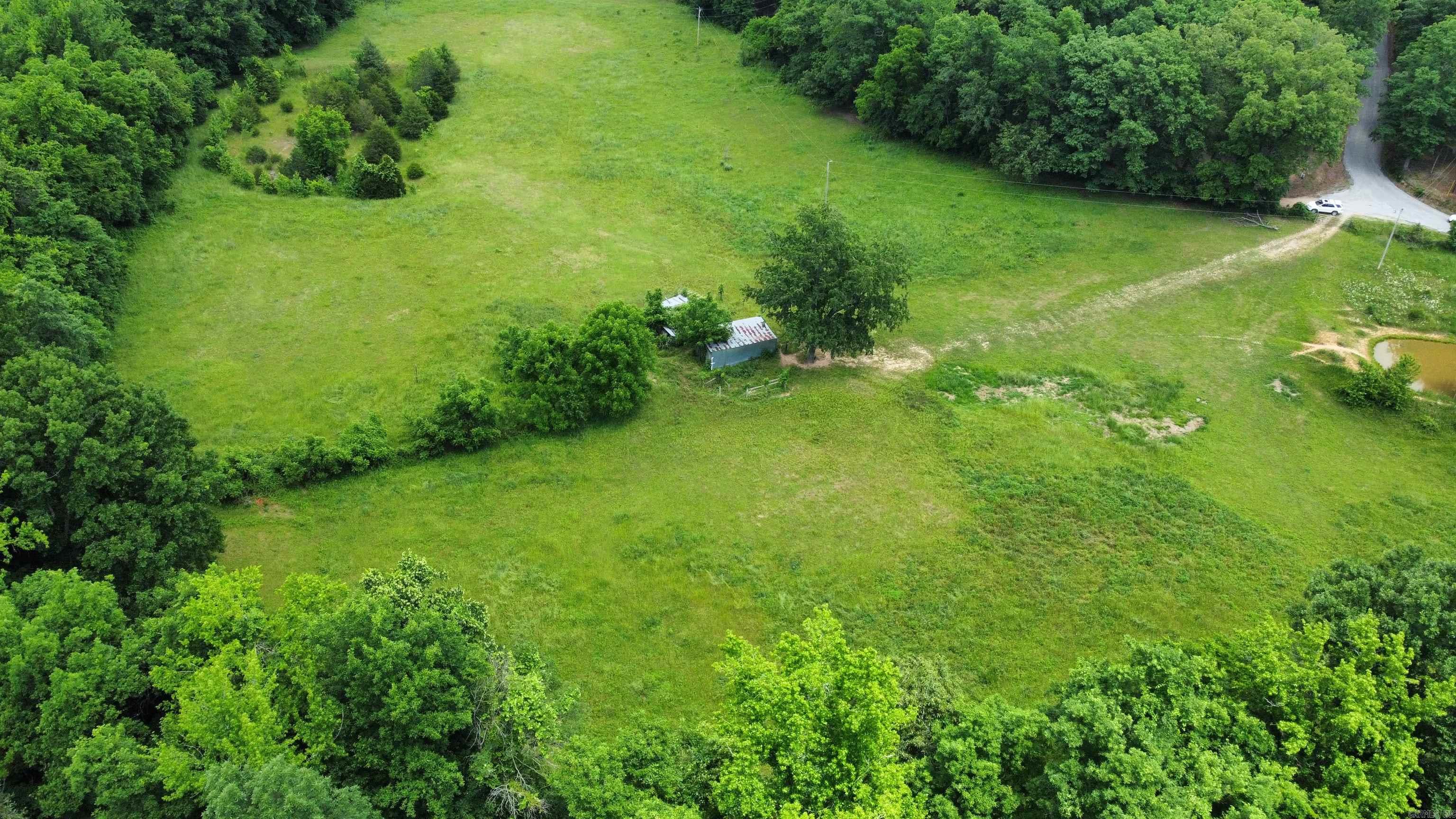Beautiful 16.14 acres m/l located just outside of Mountain View featuring gently rolling pasture land with scenic Lick Fork Creek bordering the property. This prime Ozarks acreage offers the perfect blend of open ground, peaceful creek frontage, and modern conveniences with paved road frontage plus public water, electric, and high-speed internet all available at the road. Ideal for building your dream home, hobby farm, weekend retreat, or investment property. Enjoy the beauty and tranquility of the Ozark Mountains while being just minutes from the shopping, dining, music, and outdoor attractions that make Mountain View so desirable. Rare opportunity to own usable acreage in one of North Central Arkansas’ most sought-after areas.