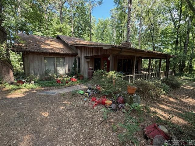 Feel secluded! This adorable cedar siding home is on 3.53 (+/-) acres in Pine Bluff! You are welcomed with the large covered front porch that you will enjoy on cool evenings after a long day. Inside you will love the wood burning fireplace in the spacious living room with the vaulted ceiling, perfect for family and friend gatherings. Watch mother nature from your floor to ceiling windows that are in the front of the home. The detached 2 car garage/barn has extra space for storage along with 2 detached large carports perfect for protecting your outside toys. With a few updates this house will truly shine! Come make this your new quiet retreat before it's gone!