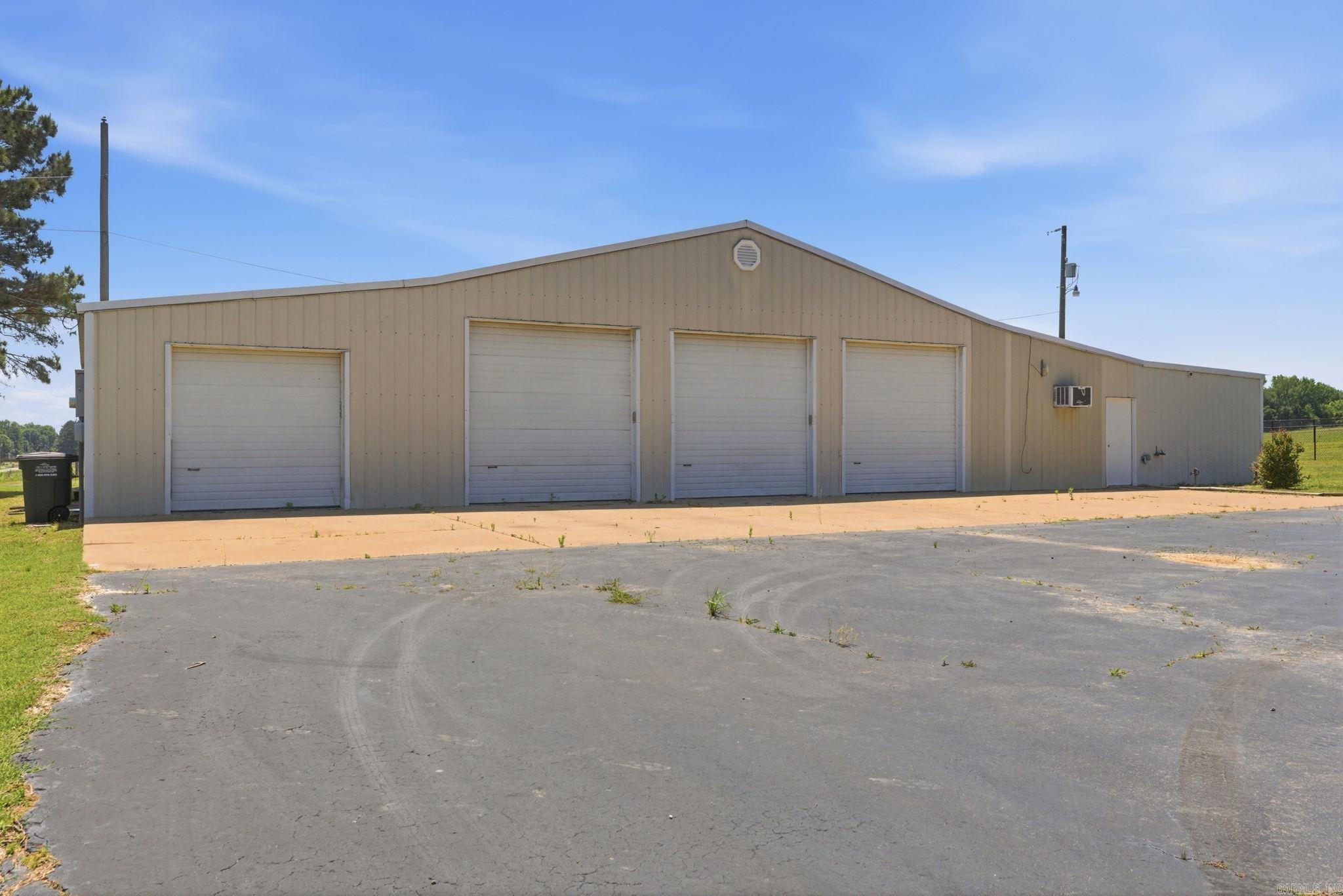 Great opportunity with endless potential in a prime Beebe location! Shop, parking lot and additional building is on 1.25 acres. This property features an approximately 3,458 SF commercial-style shop building complete with electricity, bathroom, multiple bays, and automatic garage doors. Whether you need space for a business, storage, equipment, hobbies, or future investment opportunities, this property offers flexibility and functionality. There is also an additional smaller building on the property previously used as a beauty shop that could serve a variety of purposes including office space, studio, storage, or small business use. Excellent location with tons of opportunity for residential, commercial, or mixed-use potential.