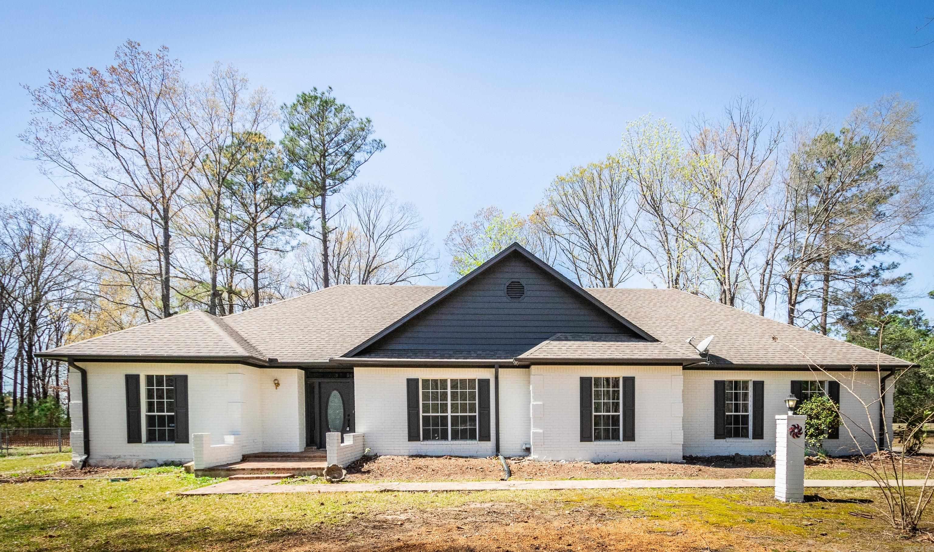 Located on a 4-acre plot, this enchanting home seamlessly blends the tranquility of country living with elegant character and practicality, positioned close to Pine Bluff's essential services. The interior, spanning about 2543 square feet, features 3 bedrooms, 2 full bathrooms, and an additional half bath, with plenty of storage space. The private driveway in a serene setting framed by mature trees. The home also boasts oversized family and dining rooms that welcome entertainment.  The kitchen's generous proportions make it ideal for celebrations and gatherings. The expansive back-porch offers a perfect vantage point to enjoy the surroundings, ideal for relaxation and entertainment. The spacious primary bedroom, benefiting from a split-floor plan, can easily accommodate a sitting room and boasts an expansive walk-in closet and shower. The home meets all needs with Roomy.