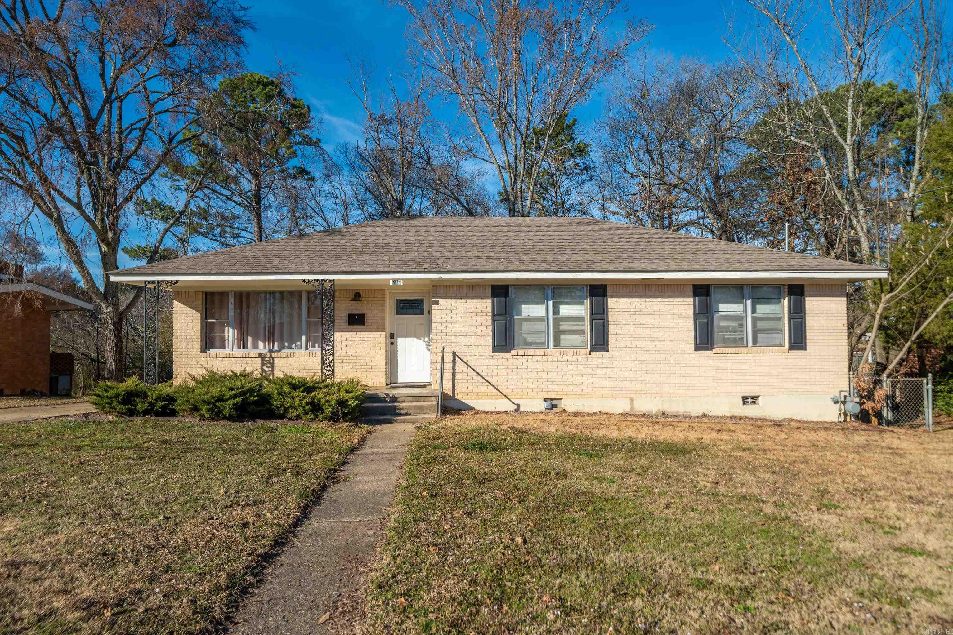 ~ Under $200K and just One mile from Oaklawn Racing ~ This fully furnished brick cottage is already income-producing and offers exceptional value in the heart of Hot Springs. Currently a nightly rental, this 3-bedroom/1.5-bath home is selling turn-key with all furnishings & appliances conveying - making it a seamless addition to your investment portfolio or a move-in ready primary residence. Inside, you’ll find a well-kept, updated interior with original hardwood floors, an inviting layout, and a bright white kitchen. A recently installed roof & solid brick construction provide long-term durability. Step outside to the back porch overlooking a fenced backyard - a peaceful setting for relaxing and a spacious place for pets. A detached one-car garage offers additional storage and convenience. Located in a quaint neighborhood just minutes from Oaklawn, downtown, and all that Hot Springs has to offer, this property delivers flexibility, charm, and income potential at a price point that’s becoming increasingly hard to find. Whether you’re expanding your portfolio or searching for a place to call home, opportunities like this are rare.