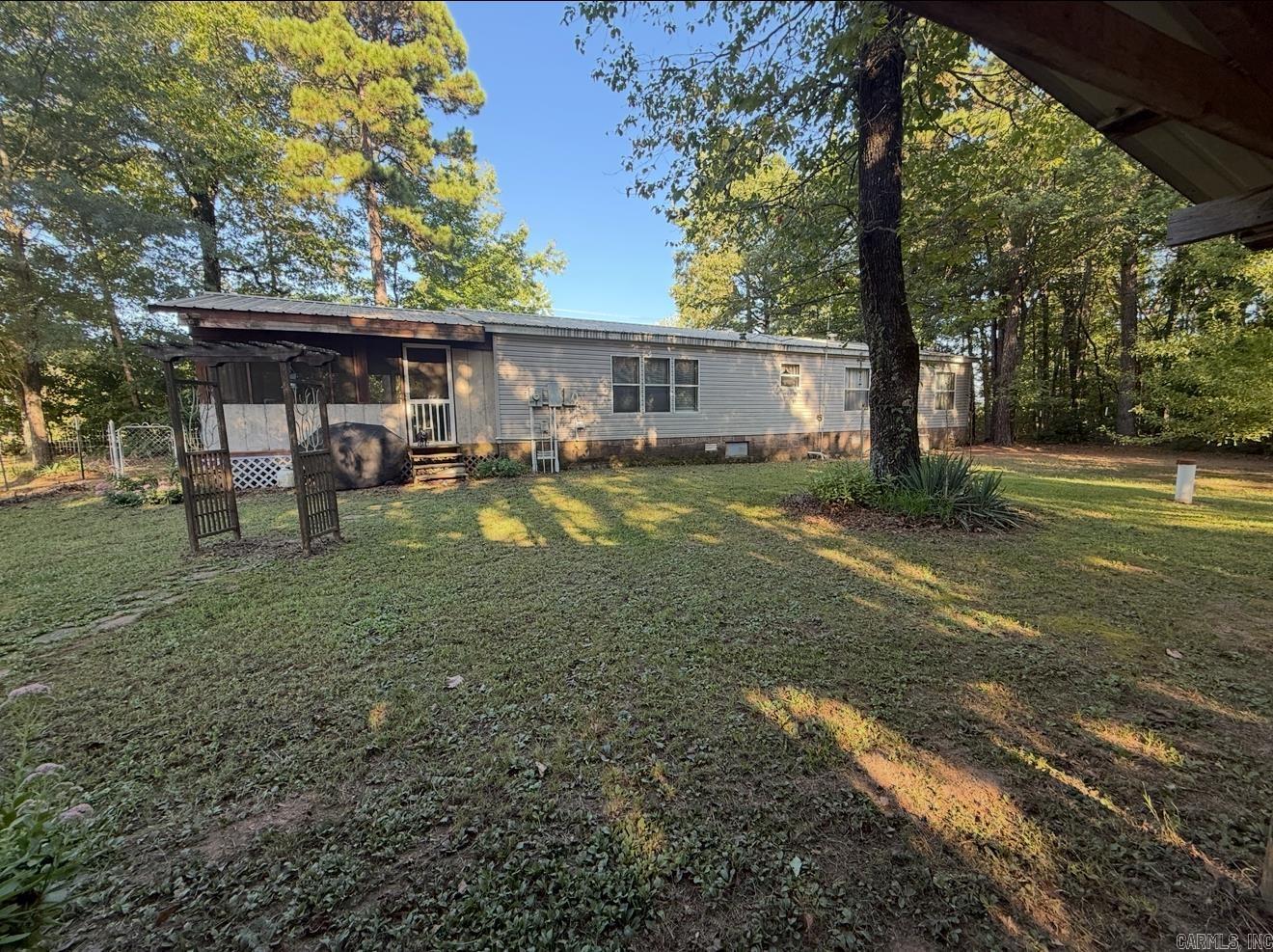 Escape to the peace and beauty of the Ozarks with this well-maintained manufactured home situated on scenic country land in Ozone, AR. This property offers a great opportunity for affordable homeownership, a weekend getaway, or quiet rural living surrounded by nature. It also features a comfortable layout with spacious living areas, plenty of natural light, and a functional kitchen with ample cabinet space. The bedrooms provide a relaxing retreat, while the surrounding land offers room for outdoor activities, gardening, or simply enjoying the privacy and open space. Located in Johnson County, the property provides peaceful country living while still being within a reasonable drive of Clarksville for shopping, dining, and everyday conveniences. Outdoor enthusiasts will appreciate the nearby access to national forest land, hiking, and recreation throughout the Ozark Mountains. Homes with land in this price range are becoming increasingly hard to find. Come see the potential this property has to offer.